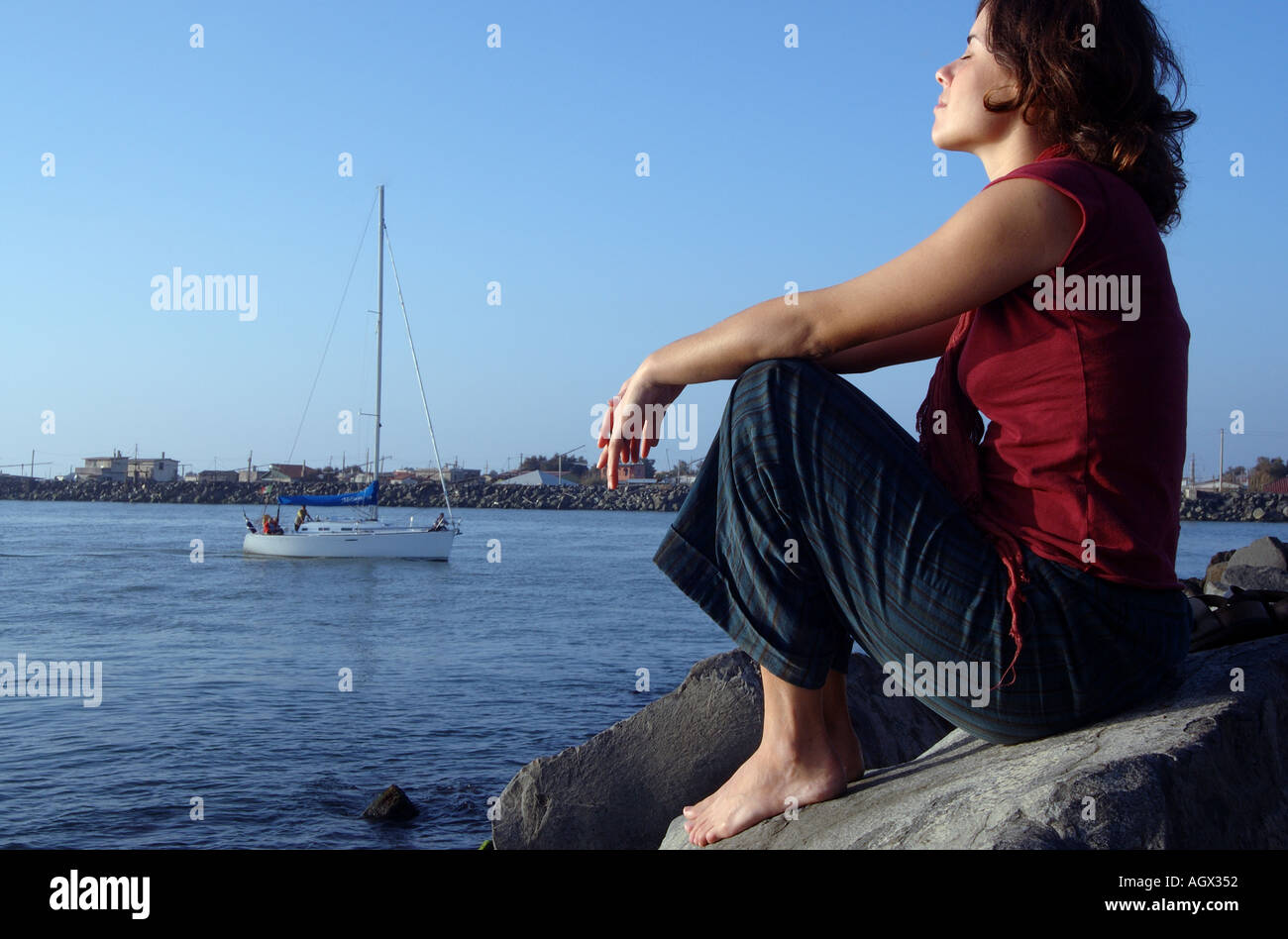 Girl sitting on a rock hi-res stock photography and images - Alamy
