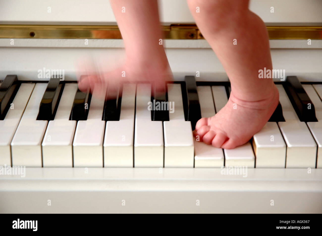 MR baby with feets on keyboard Stock Photo