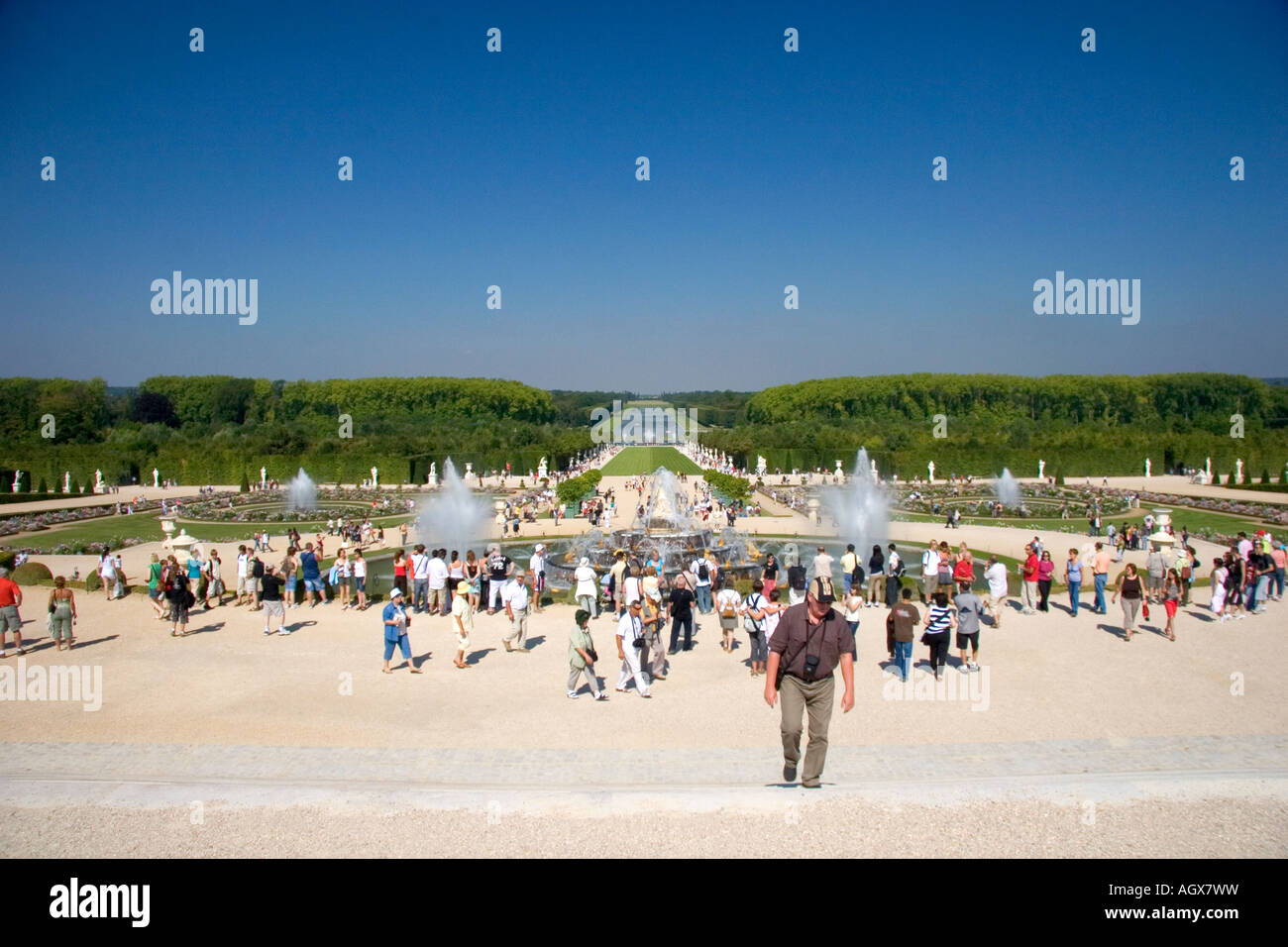 Tourists visit the formal gardens at The Palace of Versailles at Versailles in the department of Yvelines France Stock Photo