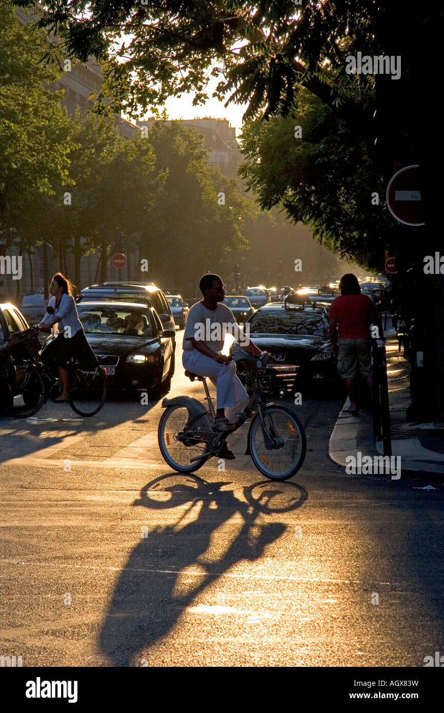 Bicyclists at sunset in Paris France Stock Photo