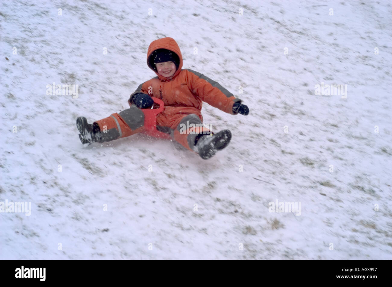 MR Fife year old boy sliding down a slope Stock Photo