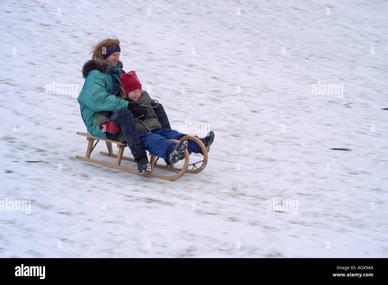 MR Mother and daughte on a sledge Stock Photo