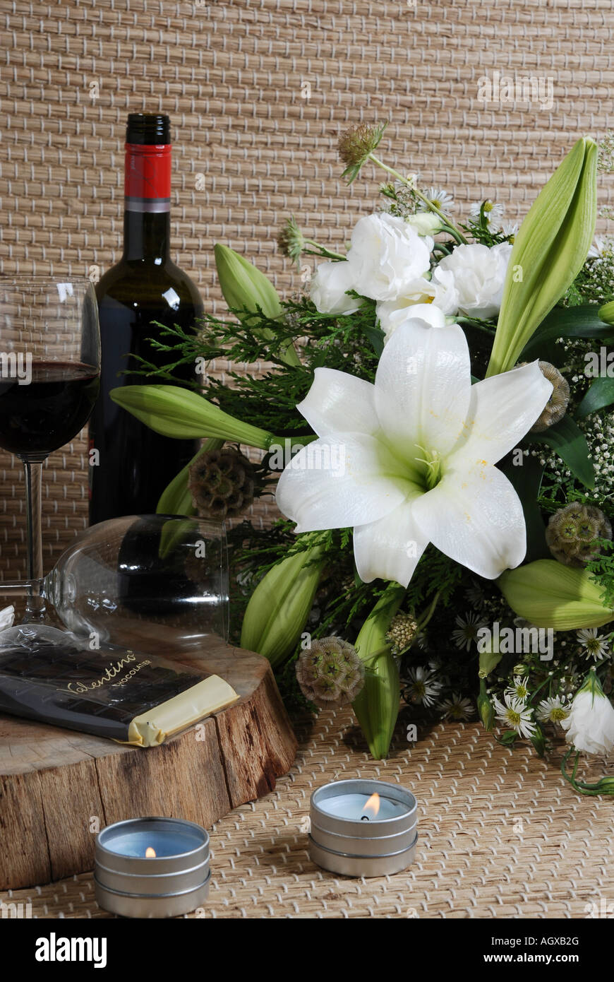 Still life with white lilly flowers red wine and candles Stock Photo ...