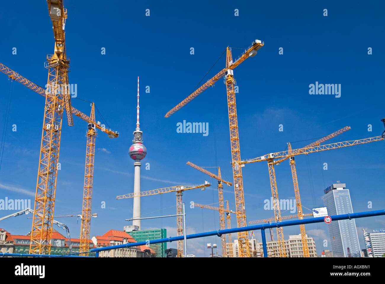 Tower cranes on a construction site in central Berlin Alexanderplatz  with television tower to rear Stock Photo