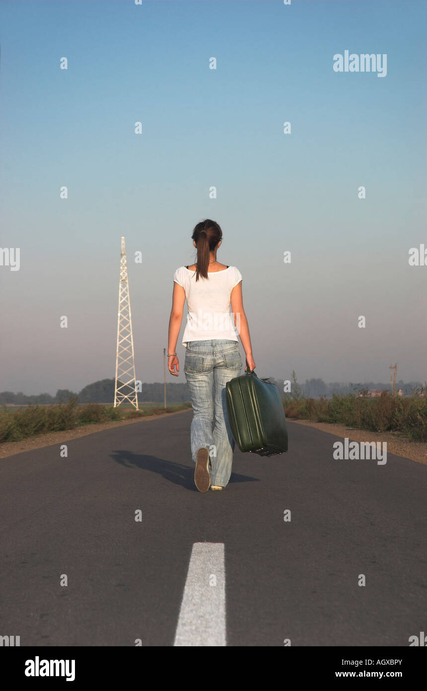 Woman alone walking back view hi-res stock photography and images - Alamy