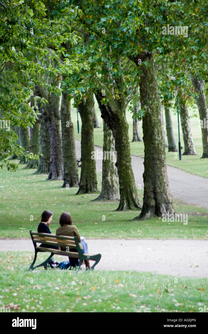 Two women on a bench in Gladstone Park Dollis Hill London Stock Photo