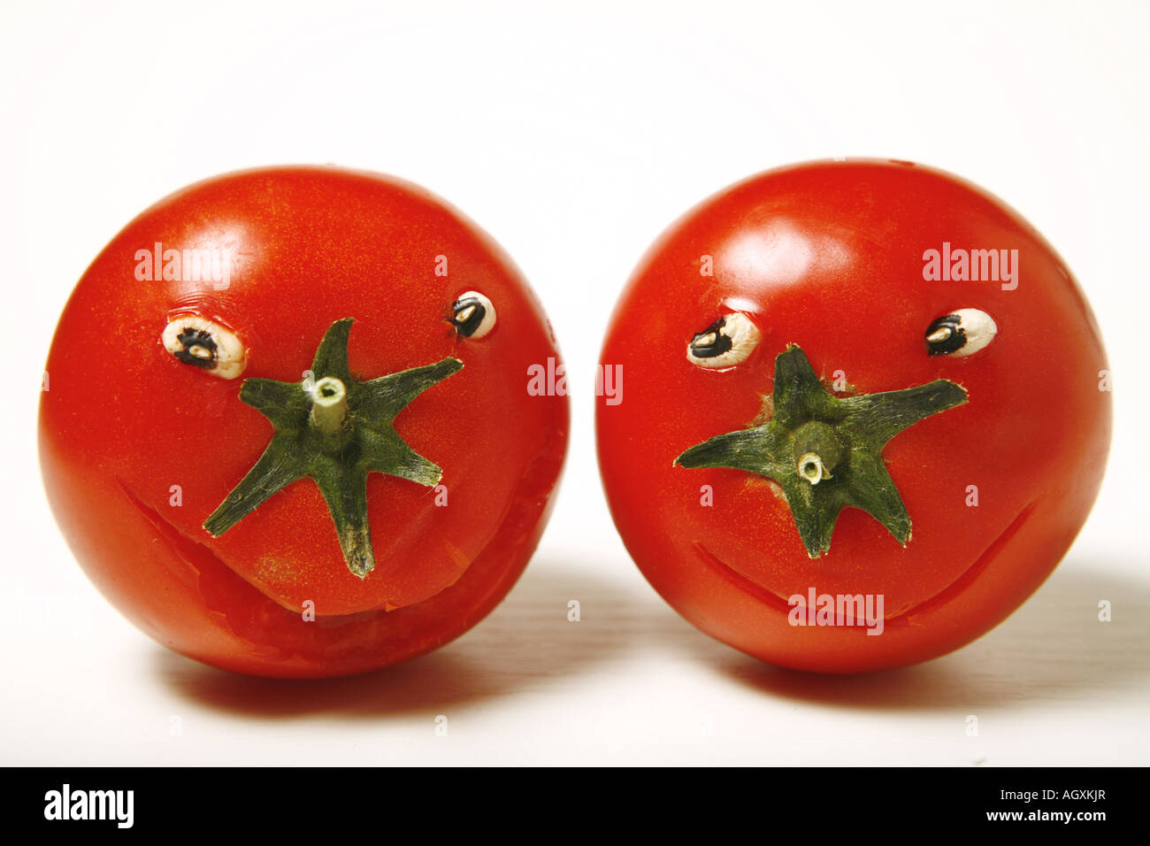 Funny tomatoes on white background Stock Photo - Alamy