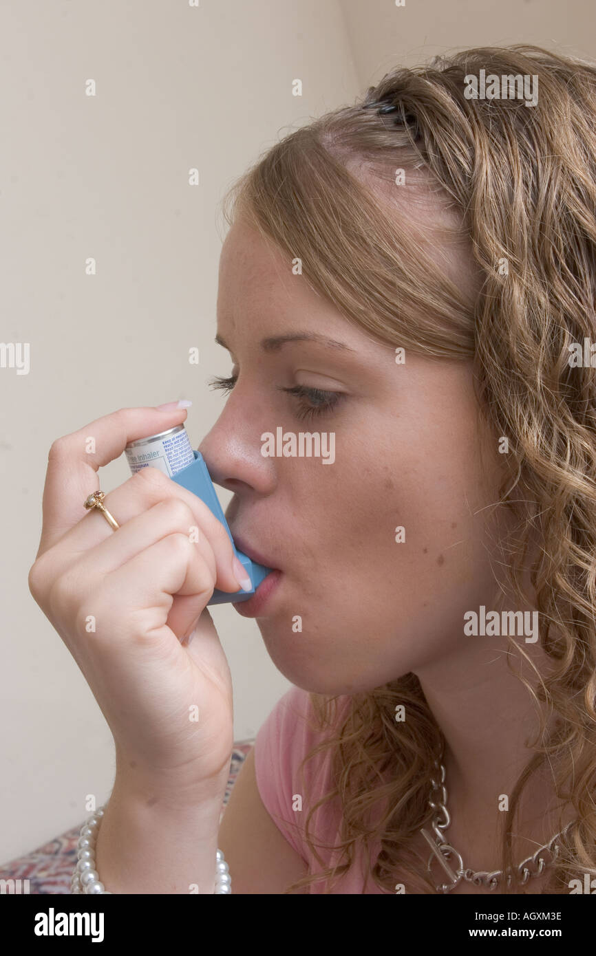 Pretty blond teenager using asthma Ventolin inhaler medication Stock ...
