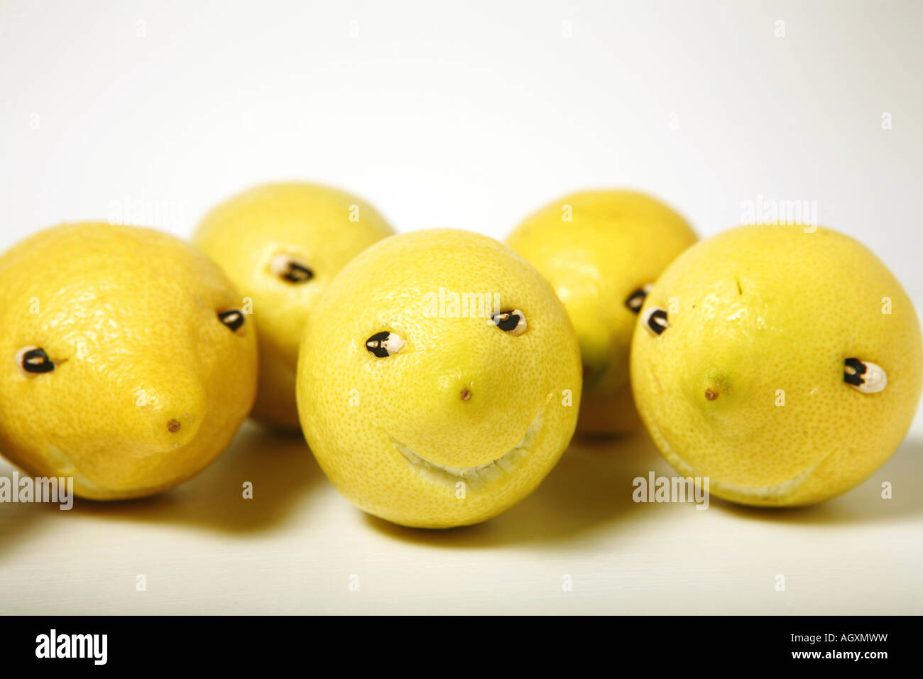 Funny lemons on white background. Stock Photo