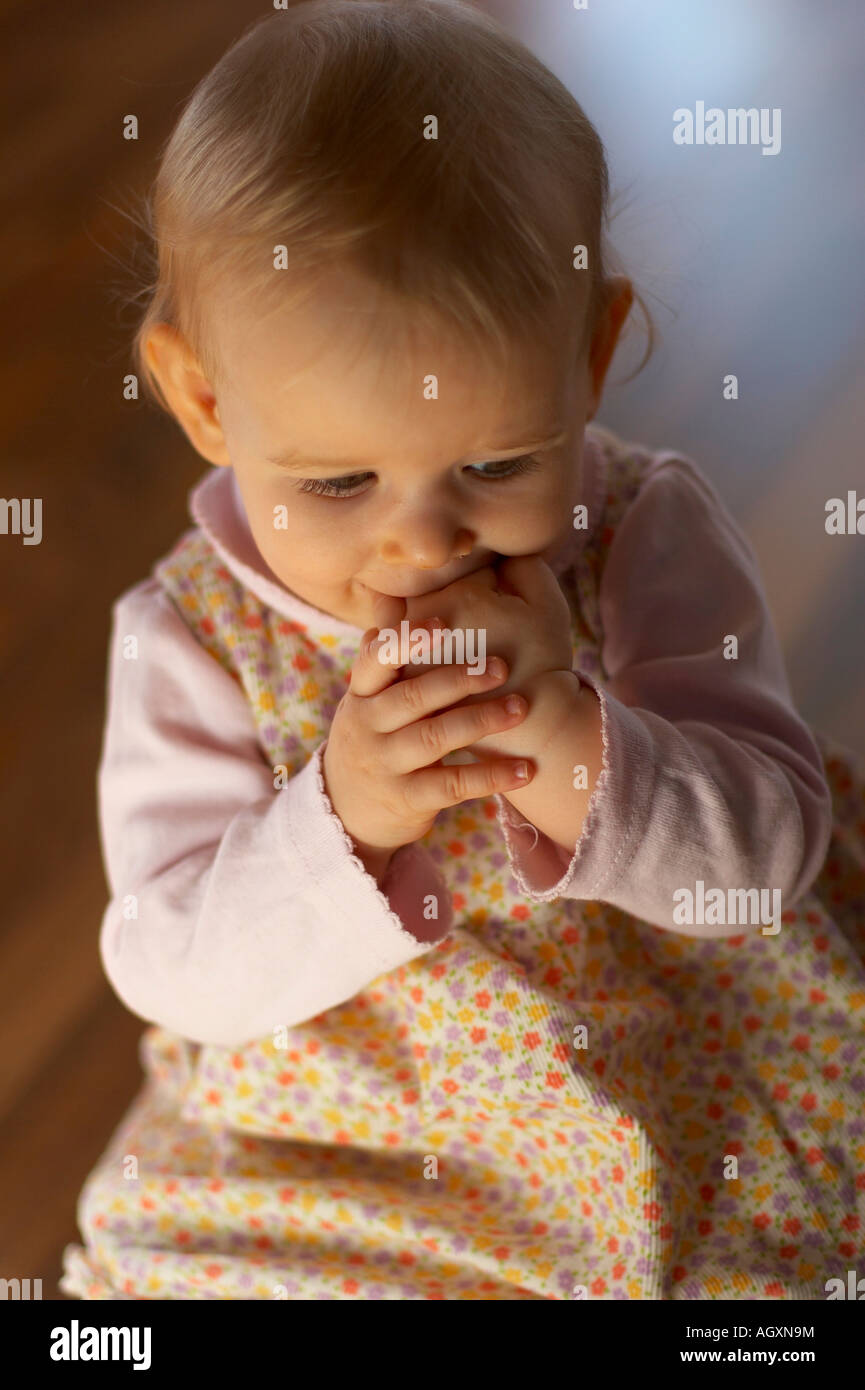 baby with hand in mouth Stock Photo