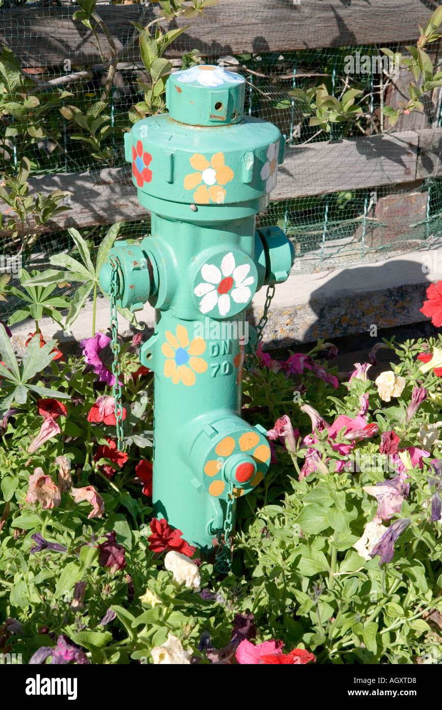 Decorated green fire hydrant in Sauze d Oulx Italy Stock Photo