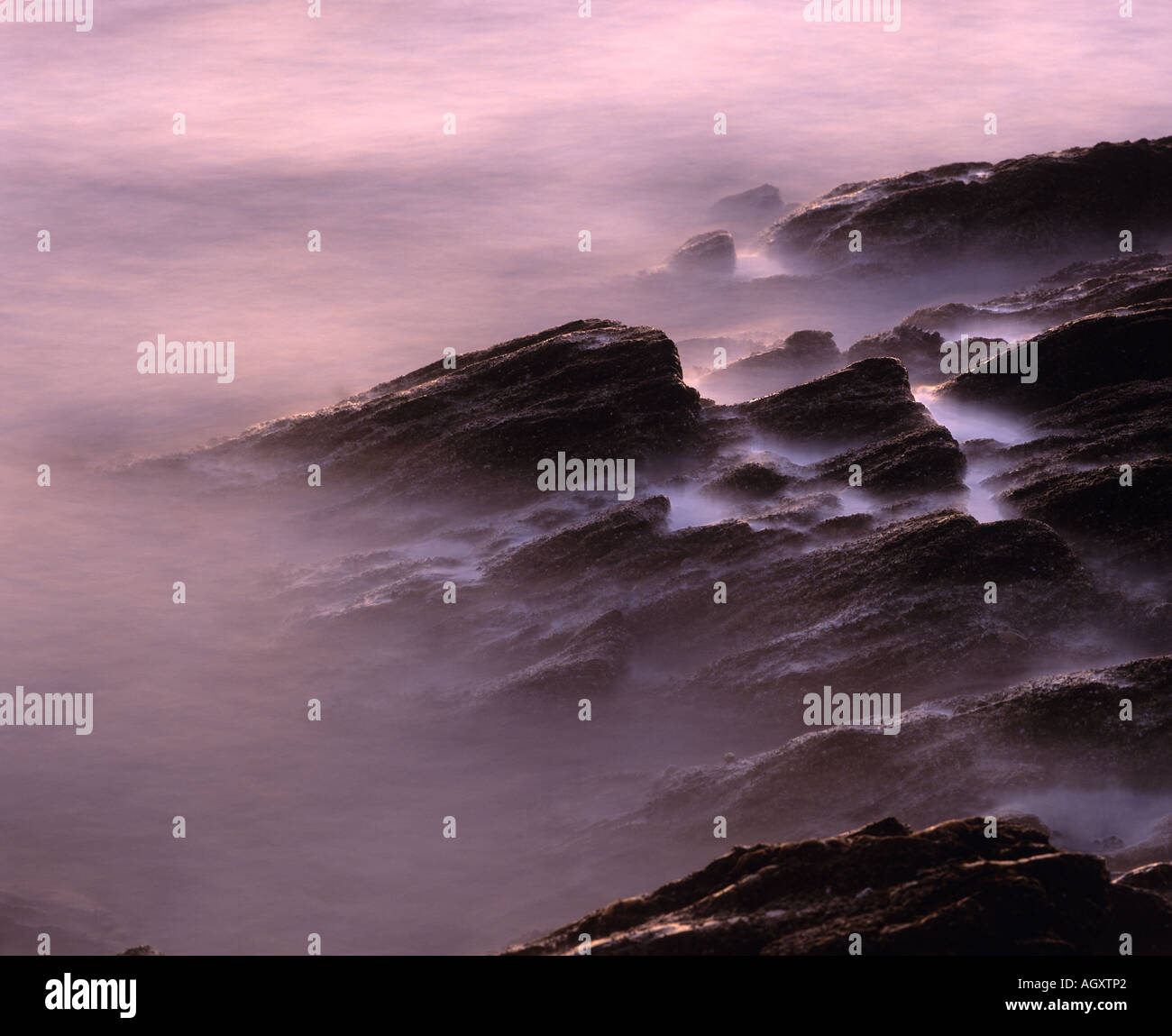 Rocky coast, blurred waves, Machrihanish Bay, Kintyre, Argyll, Scotland, UK Stock Photo
