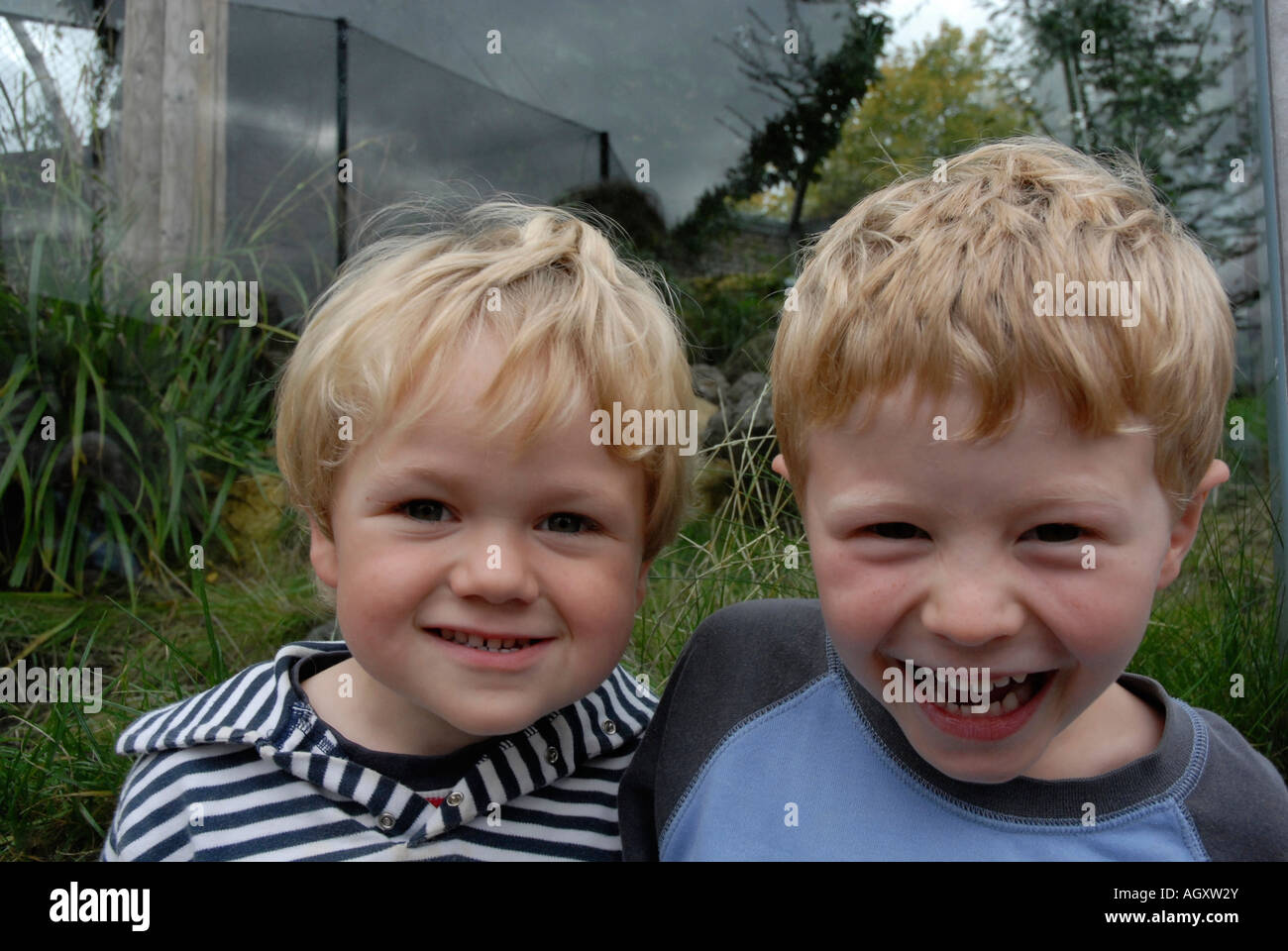 Portrait of two boys standing together and smiling Stock Photo - Alamy