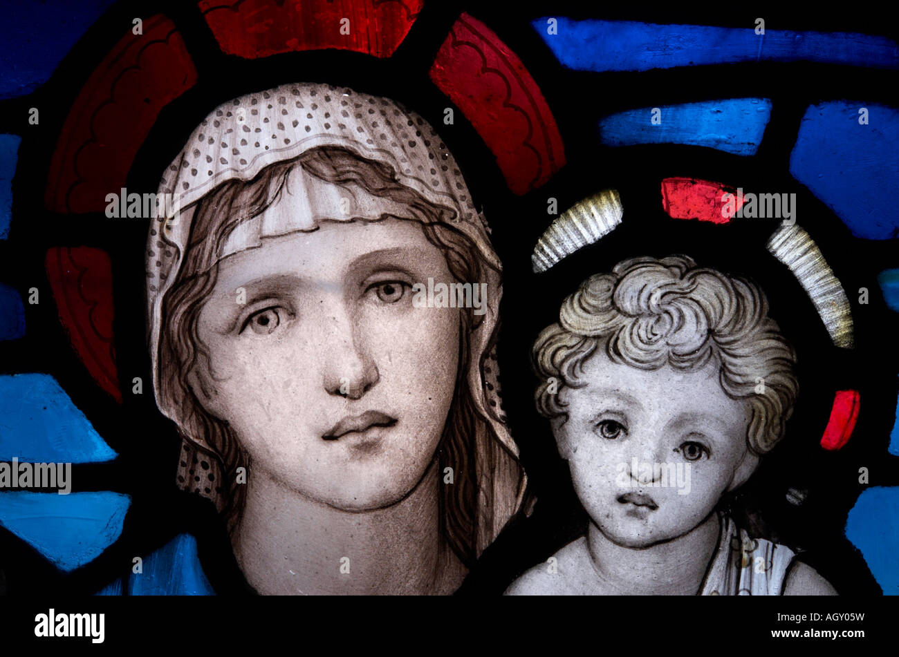 Saint Mary and baby Jesus depicted on a window in Gloucester Cathedral cloister England Stock Photo