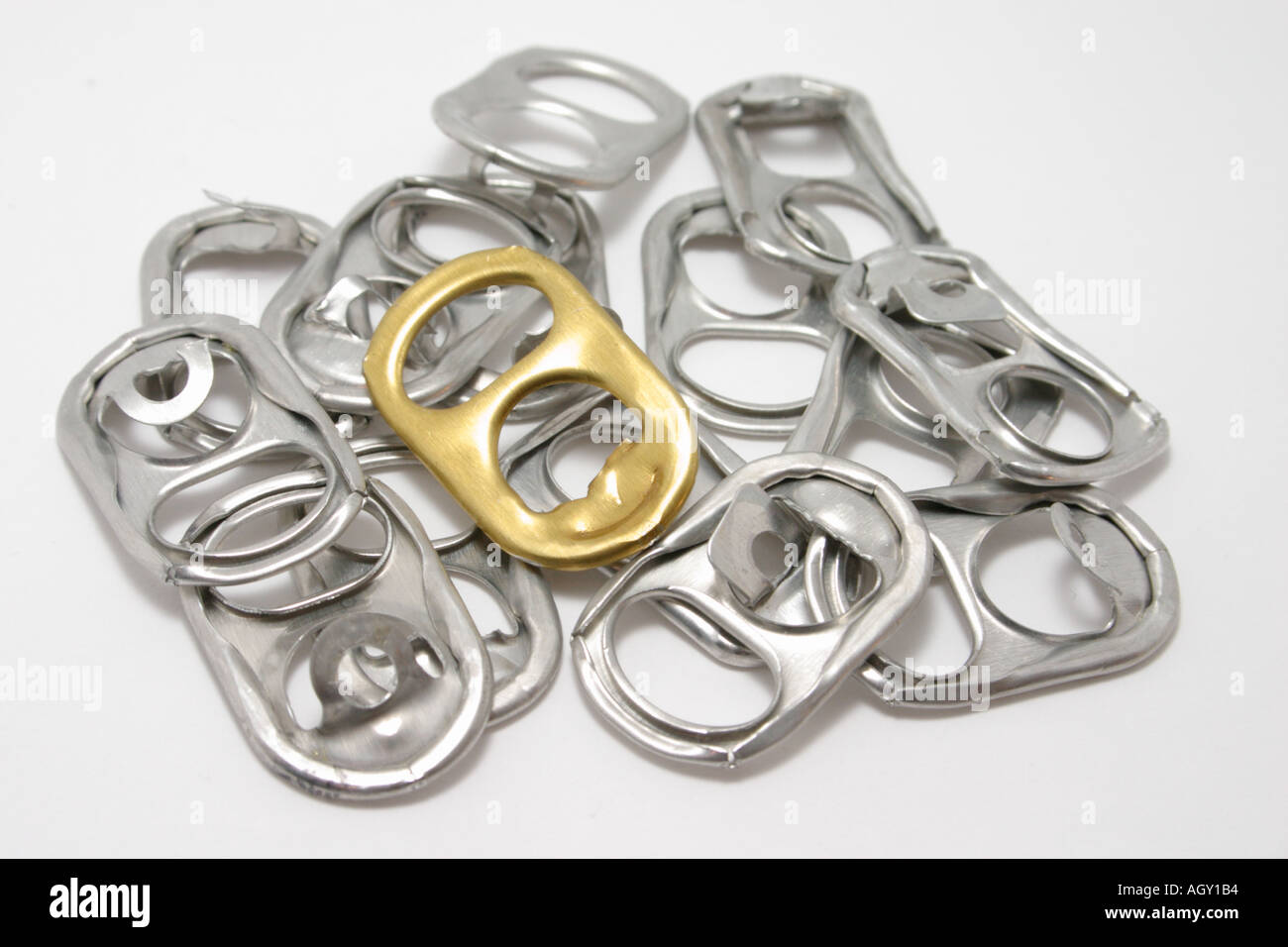 pull ring tabs from soft drink can with a single golden tab in the middle  Concept stand out different Stock Photo - Alamy
