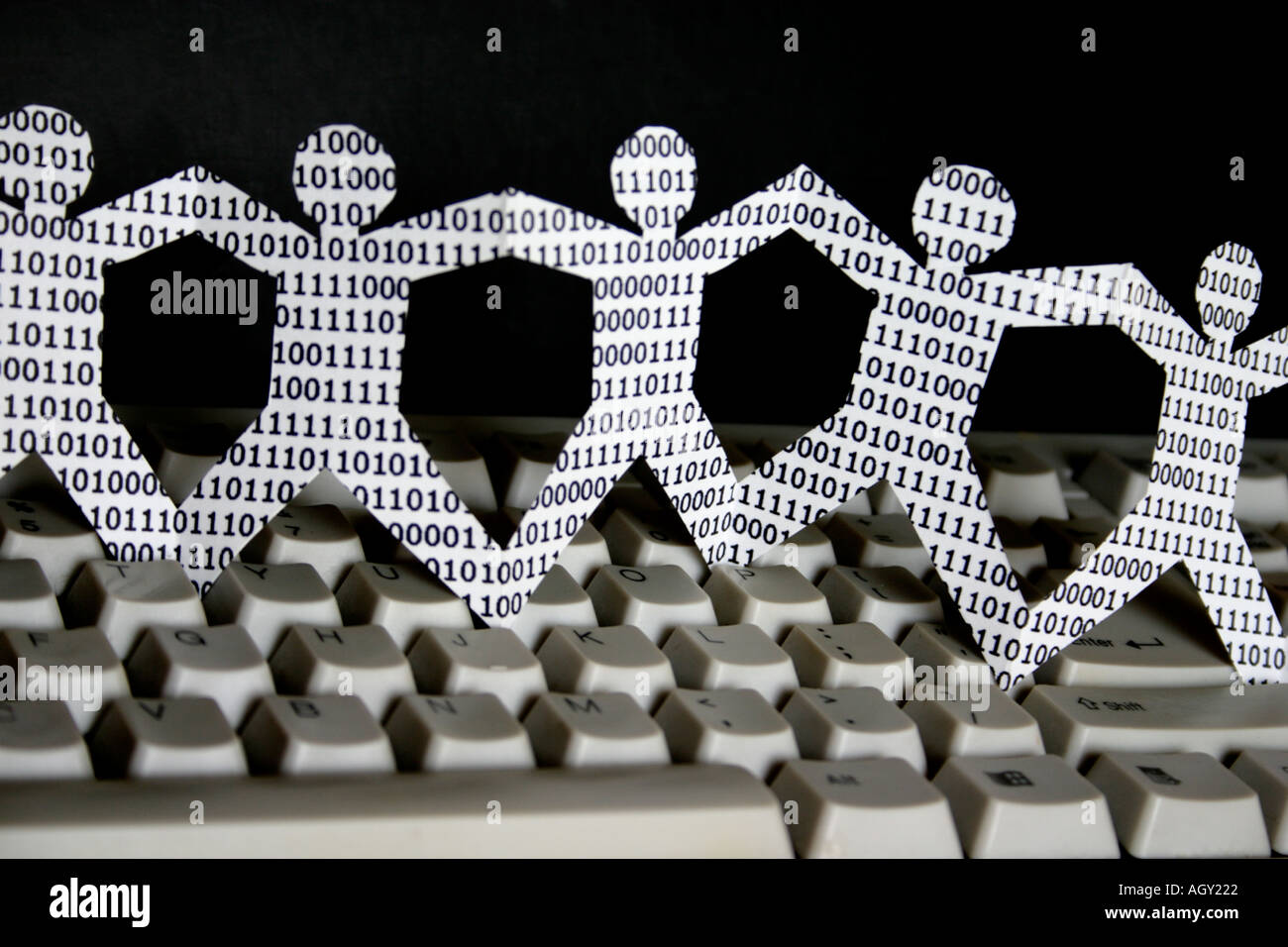 symbolic knowledge workers in the information technology industry paper dolls with binary numbers Stock Photo