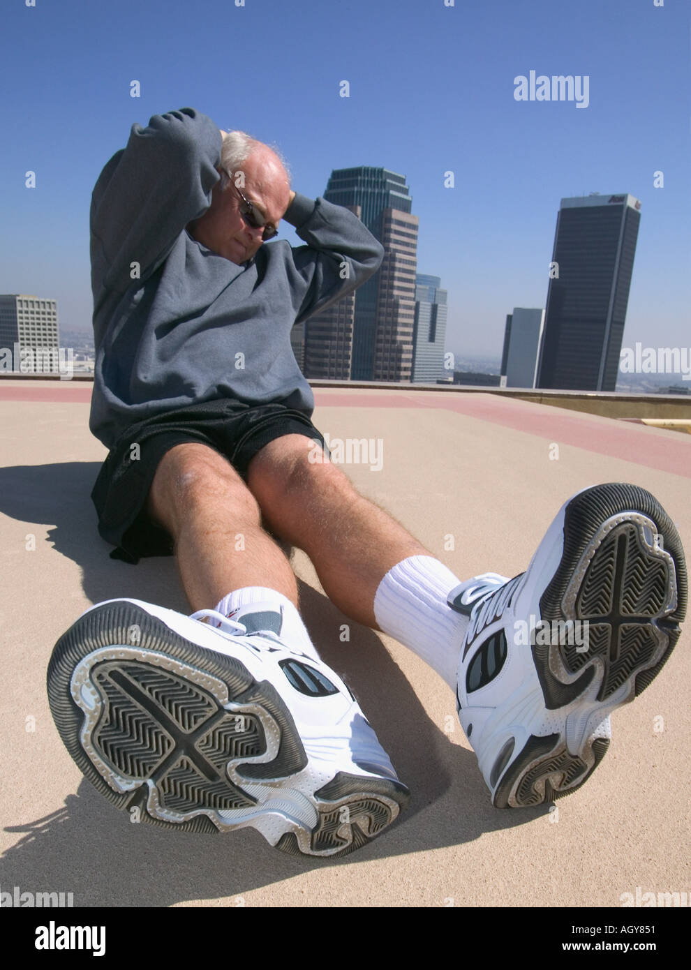 Senior Executive Exercising On Roof On Hi Rise Office Building Downtown senior-executive-exercising-on-roof-on-hi-rise-office-building-downtown