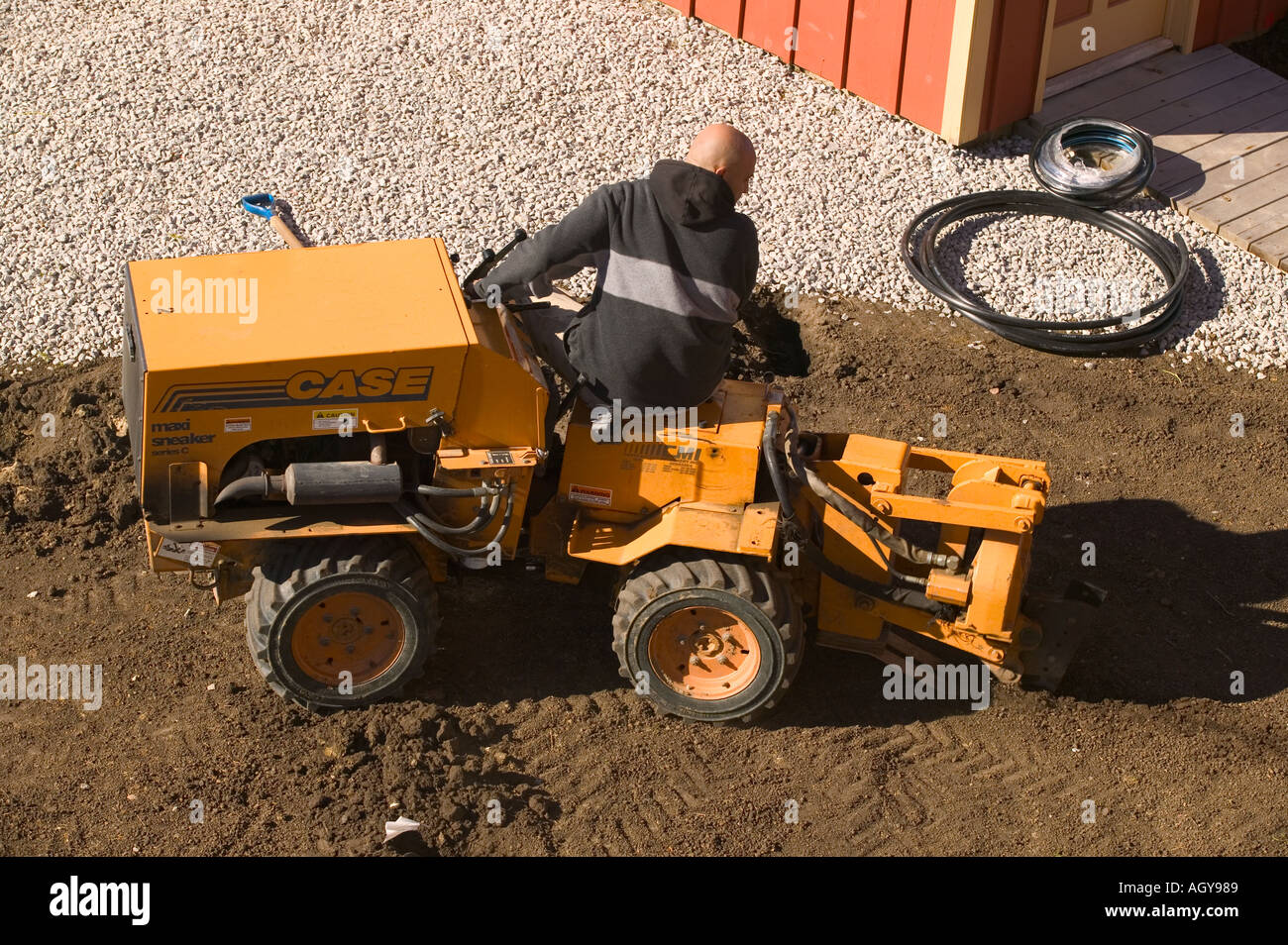 Trencher used to pull pipe for underground sprinkler system Stock Photo