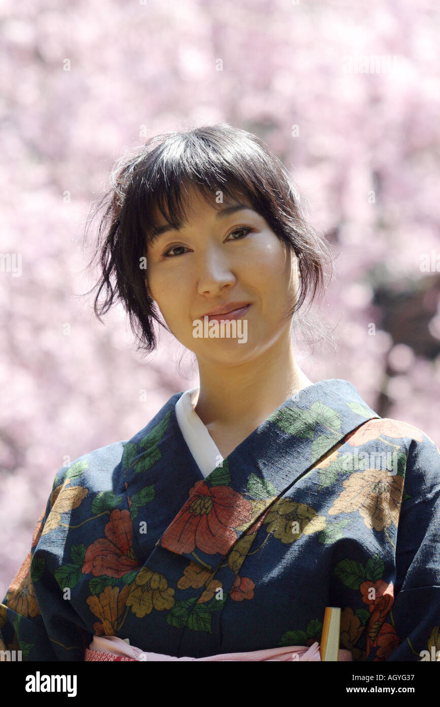 Portrait of a Japanese woman wearing Kimono cherry blossom background
