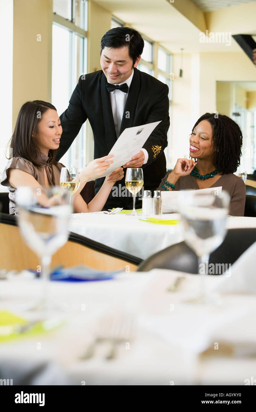 Businesswoman ordering meal in restaurant Stock Photo