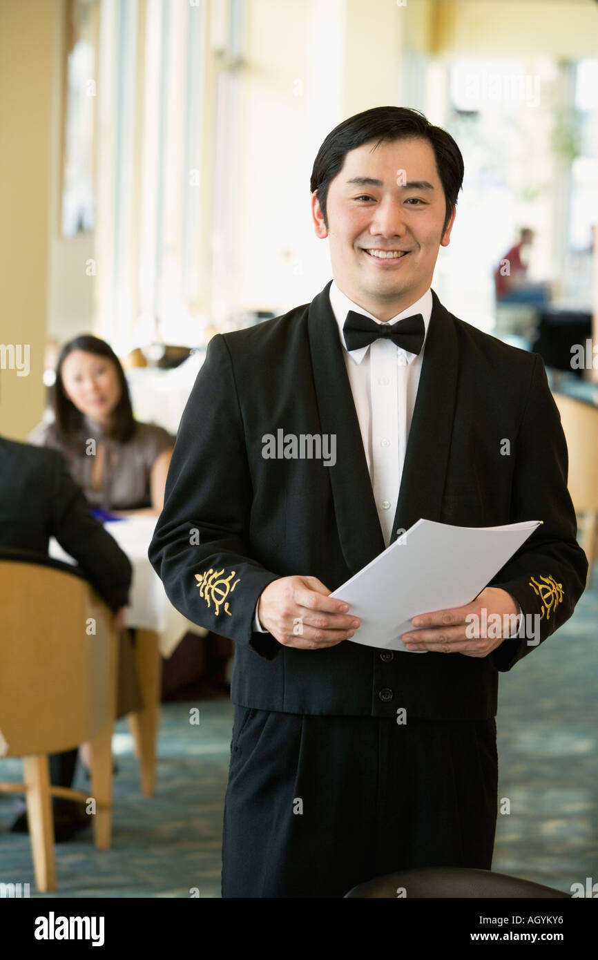 Asian male waiter at upscale restaurant Stock Photo