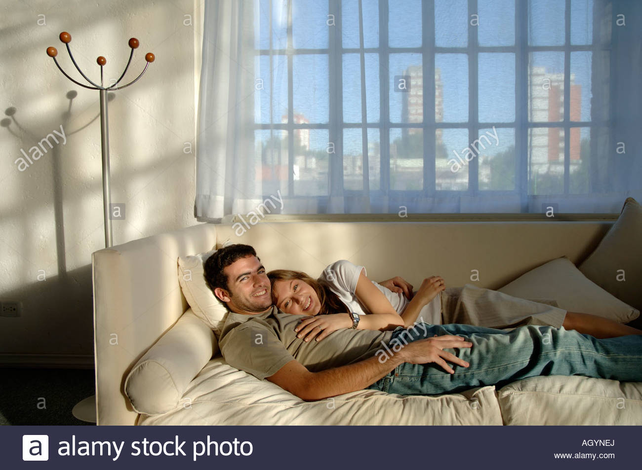 Hispanic Couple Laying Together On Sofa Stock Photo 14310521 Alamy