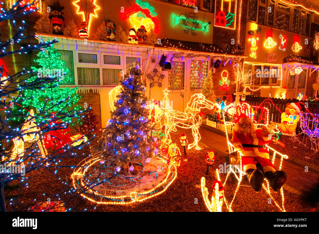 Row of Council Houses with Illuminated Christmas Decorations Stock