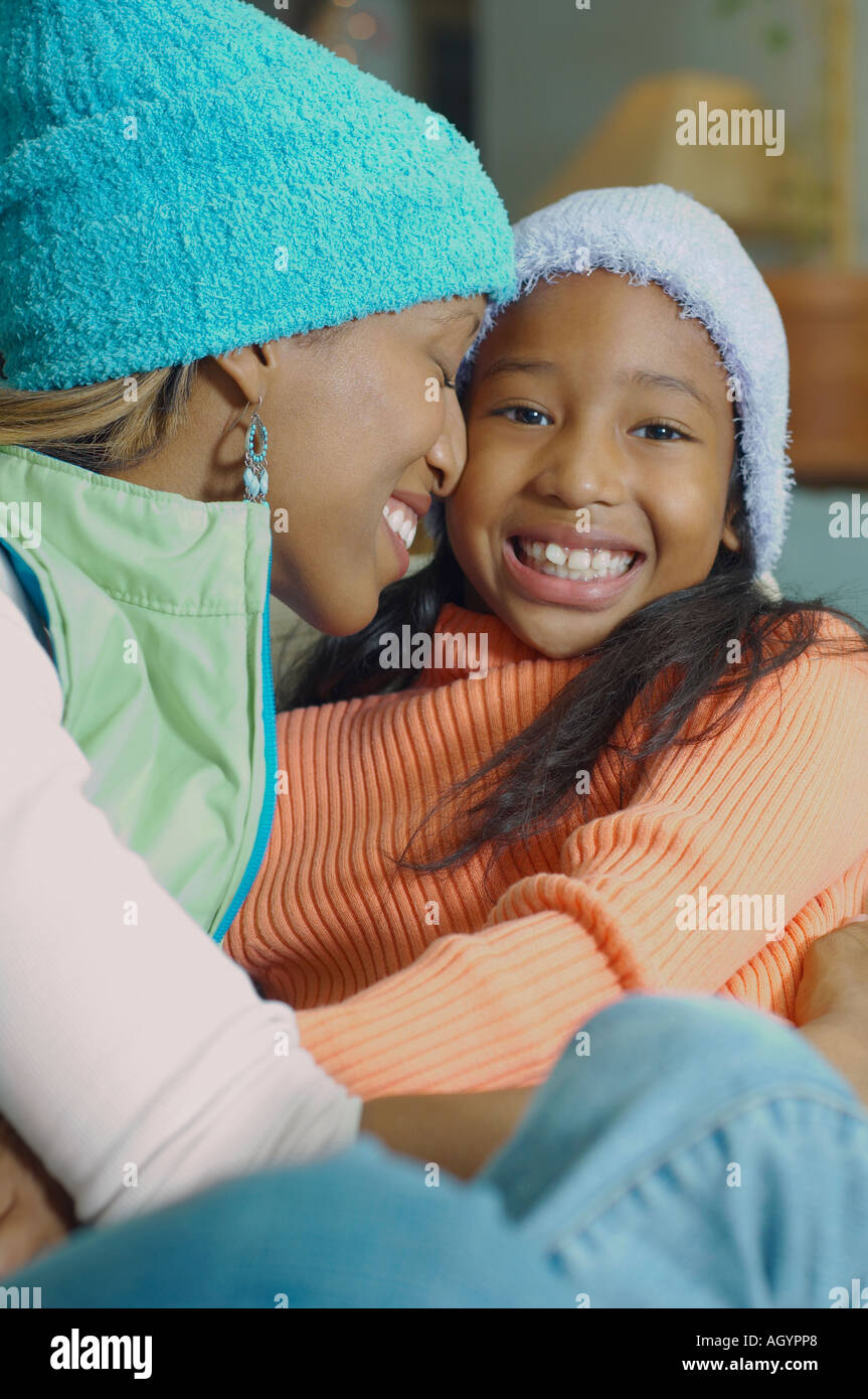 African American mother and daughter hugging Stock Photo
