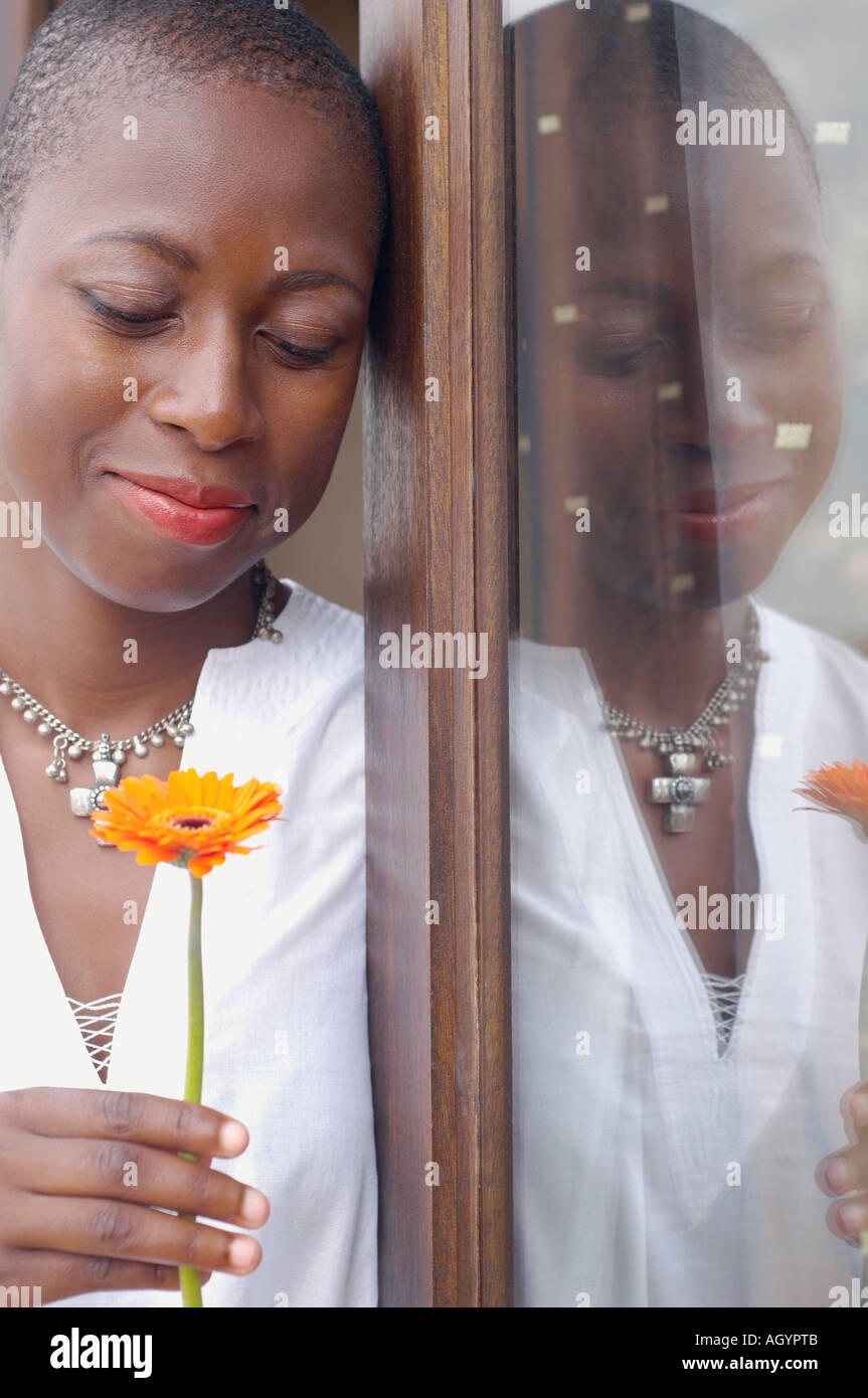 African American woman holding flower Stock Photo