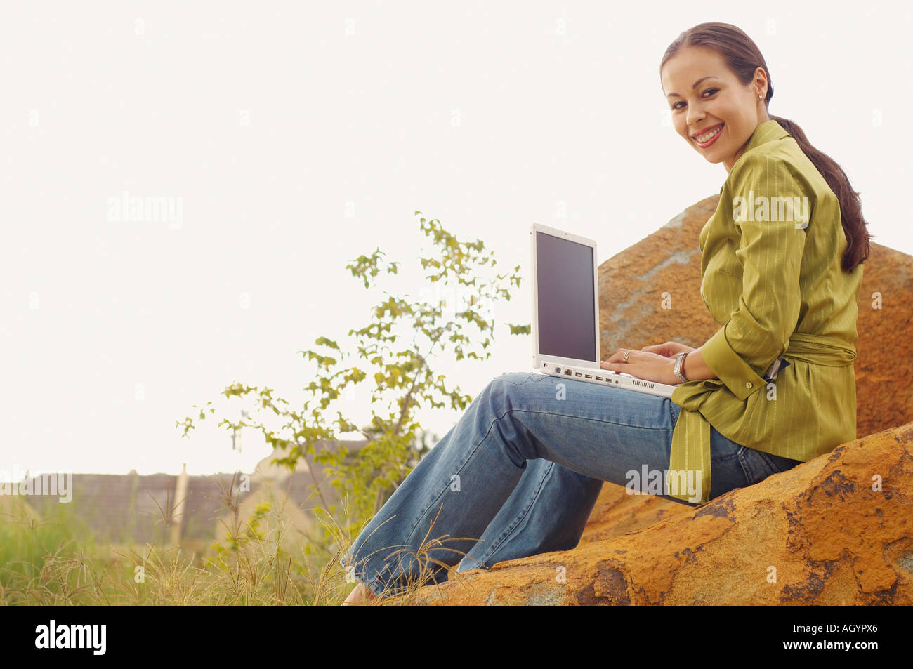 Woman with laptop outdoors Stock Photo