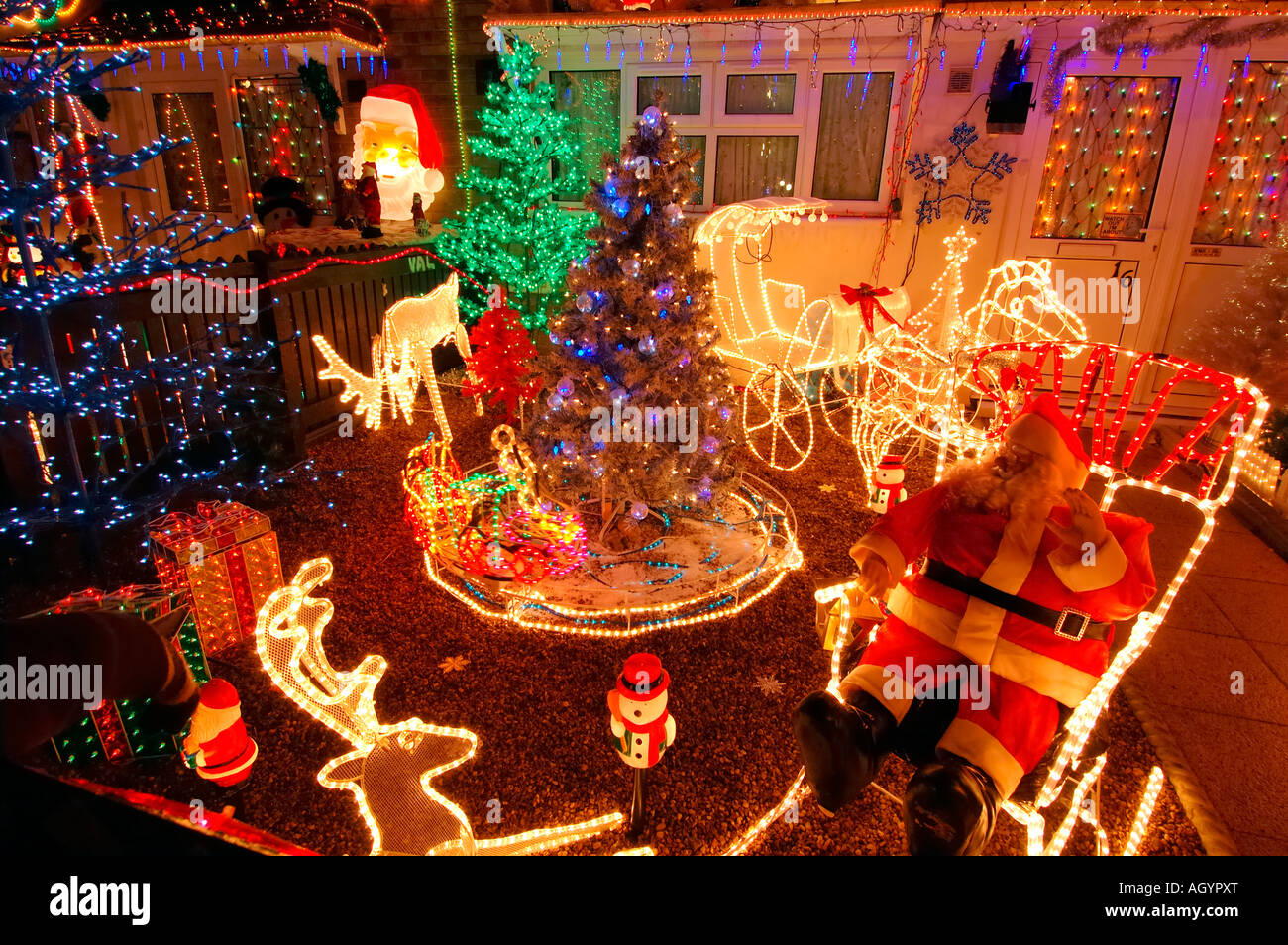 Row of Council Houses with Illuminated Christmas Decorations Stock