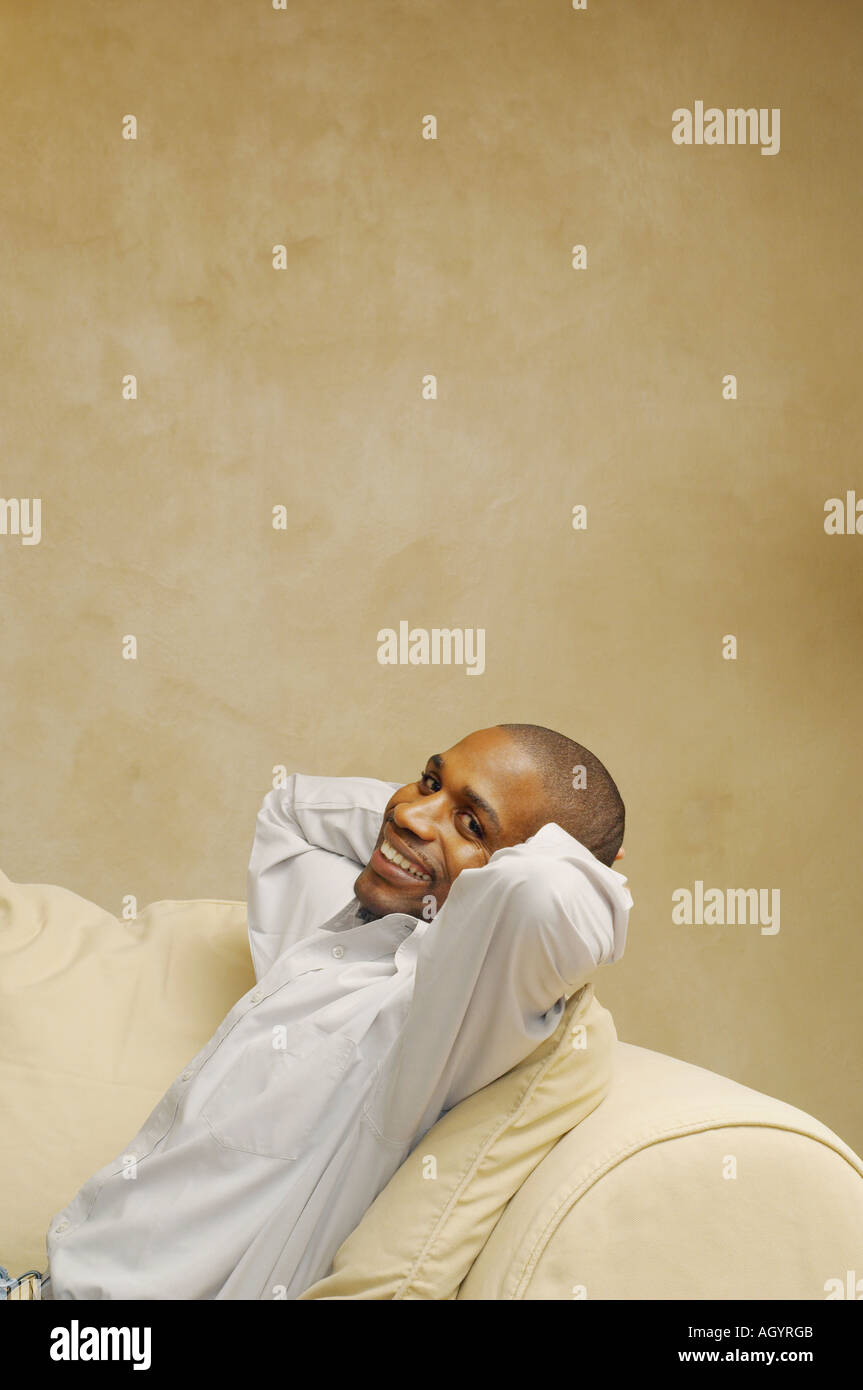 African American man sitting on sofa Stock Photo