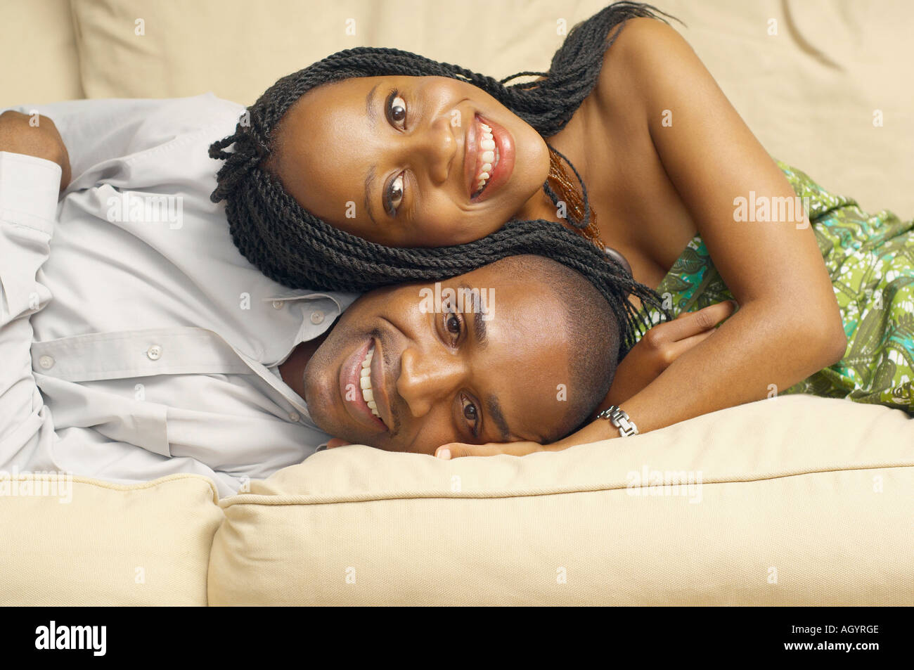 African American couple lying on sofa Stock Photo