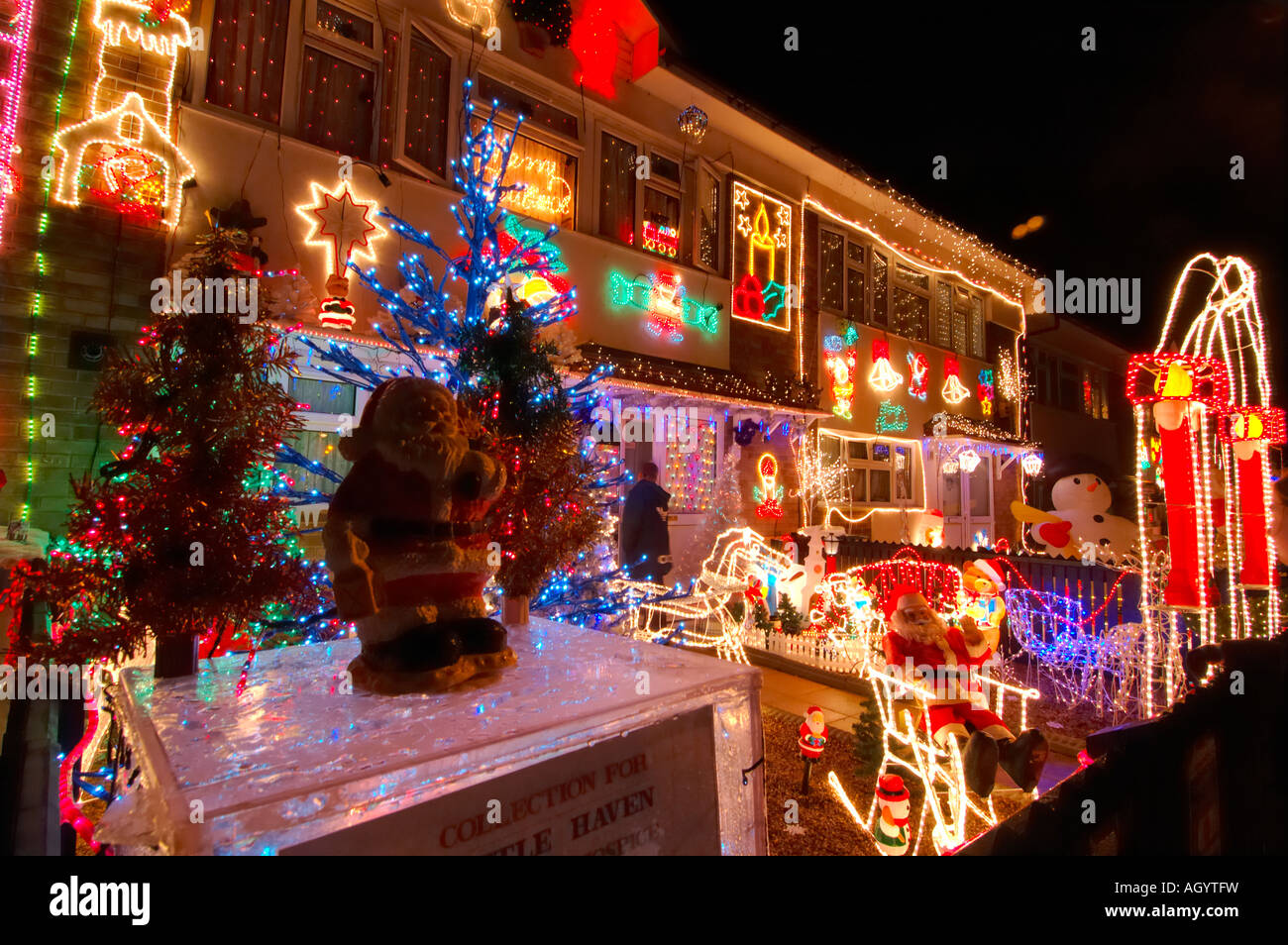 Row of Council Houses with Illuminated Christmas Decorations Stock