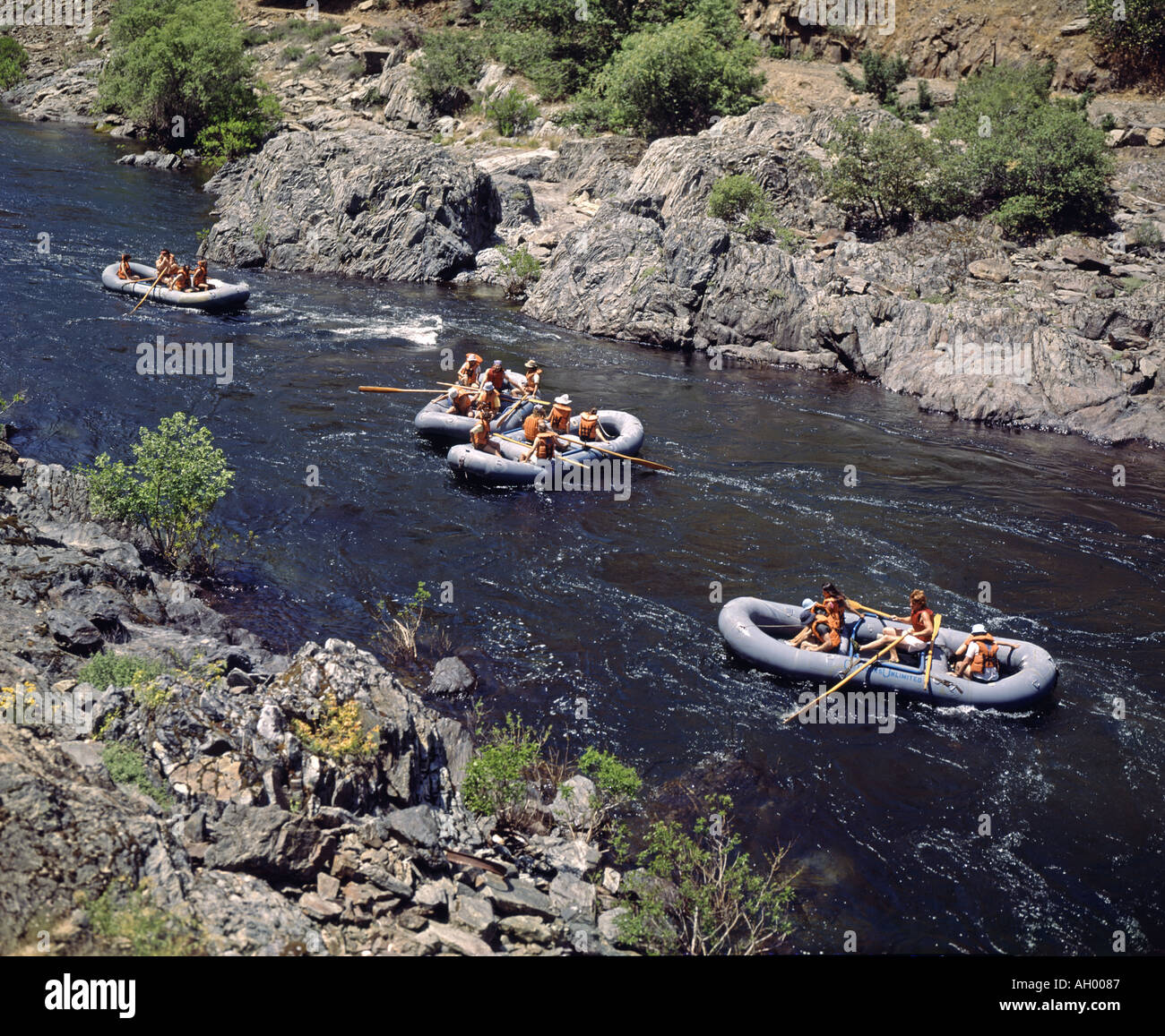 adventurers in four inflatable rafts floating down the Merced River in