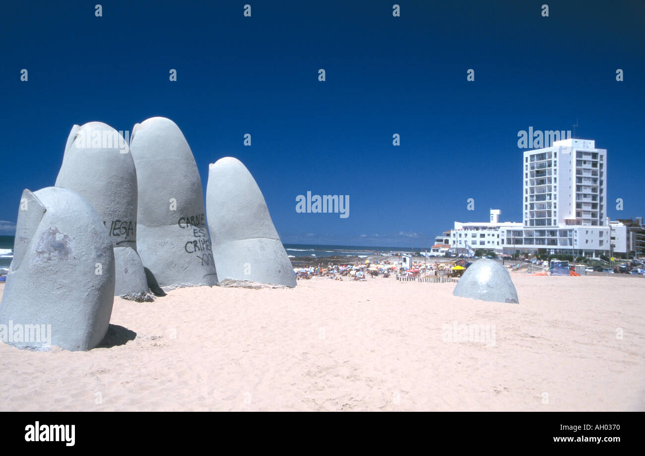 Hand in the Sand at Punta del Este Uruguay Montevideo fingers sticking our  of the sand pointing up at a very blue sky Stock Photo - Alamy
