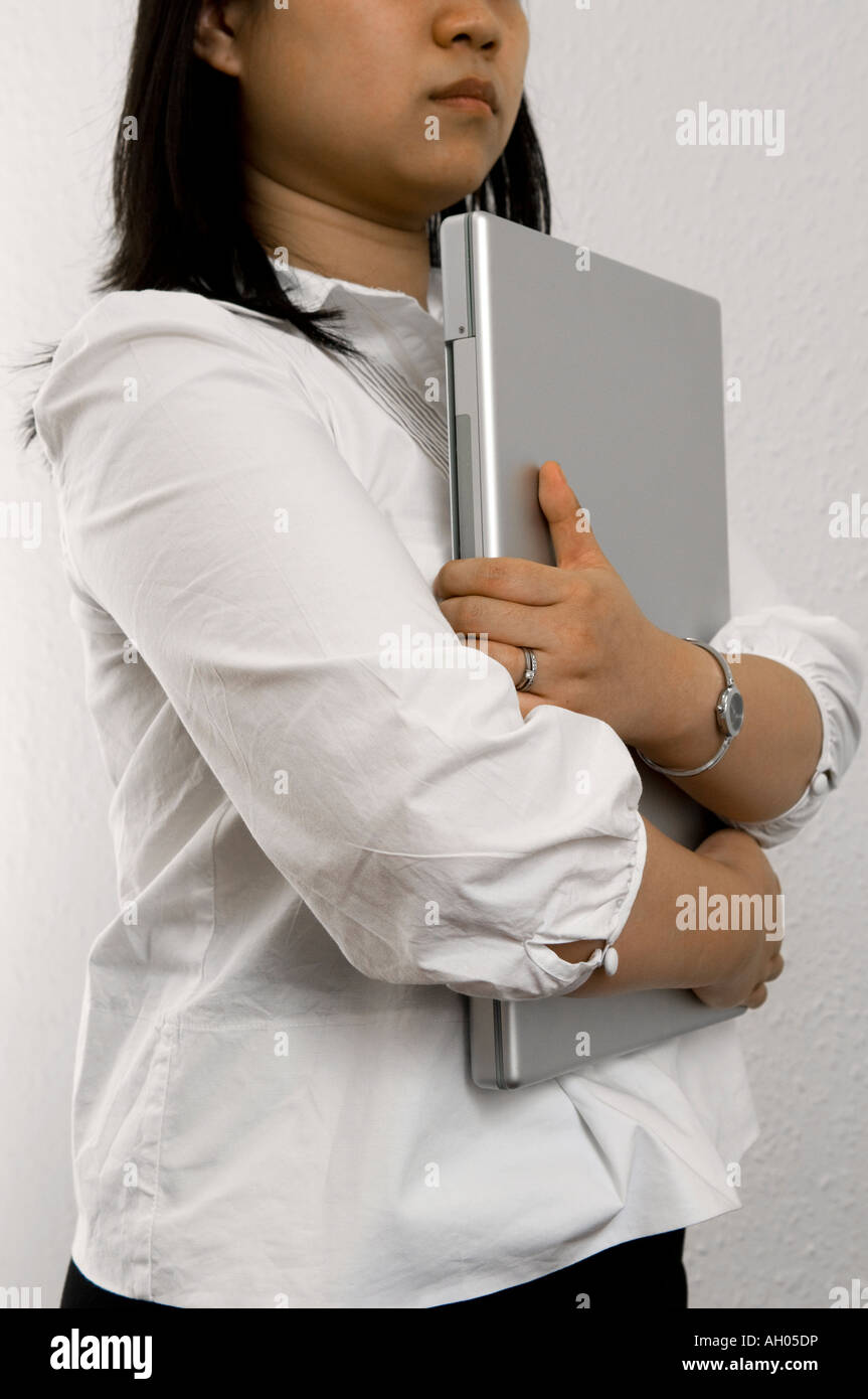 Woman holding laptop to chest hires stock photography and images Alamy
