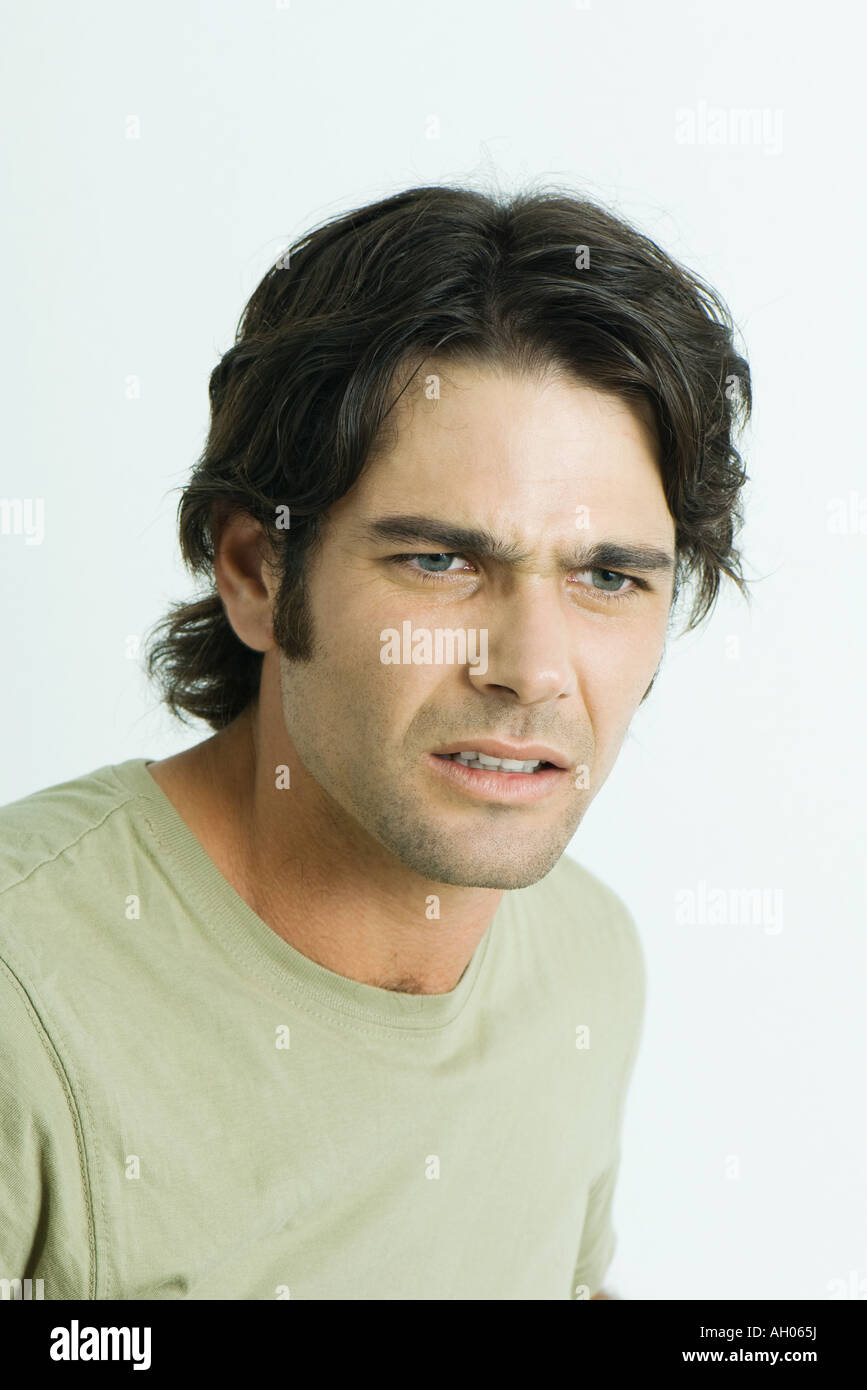 Man furrowing brow, looking away, portrait Stock Photo