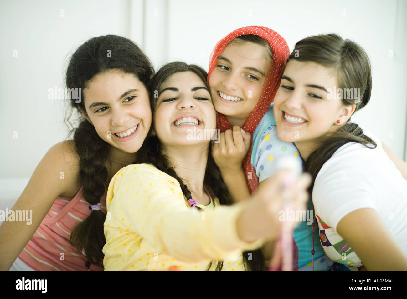 Young female friends posing for photo together Stock Photo - Alamy