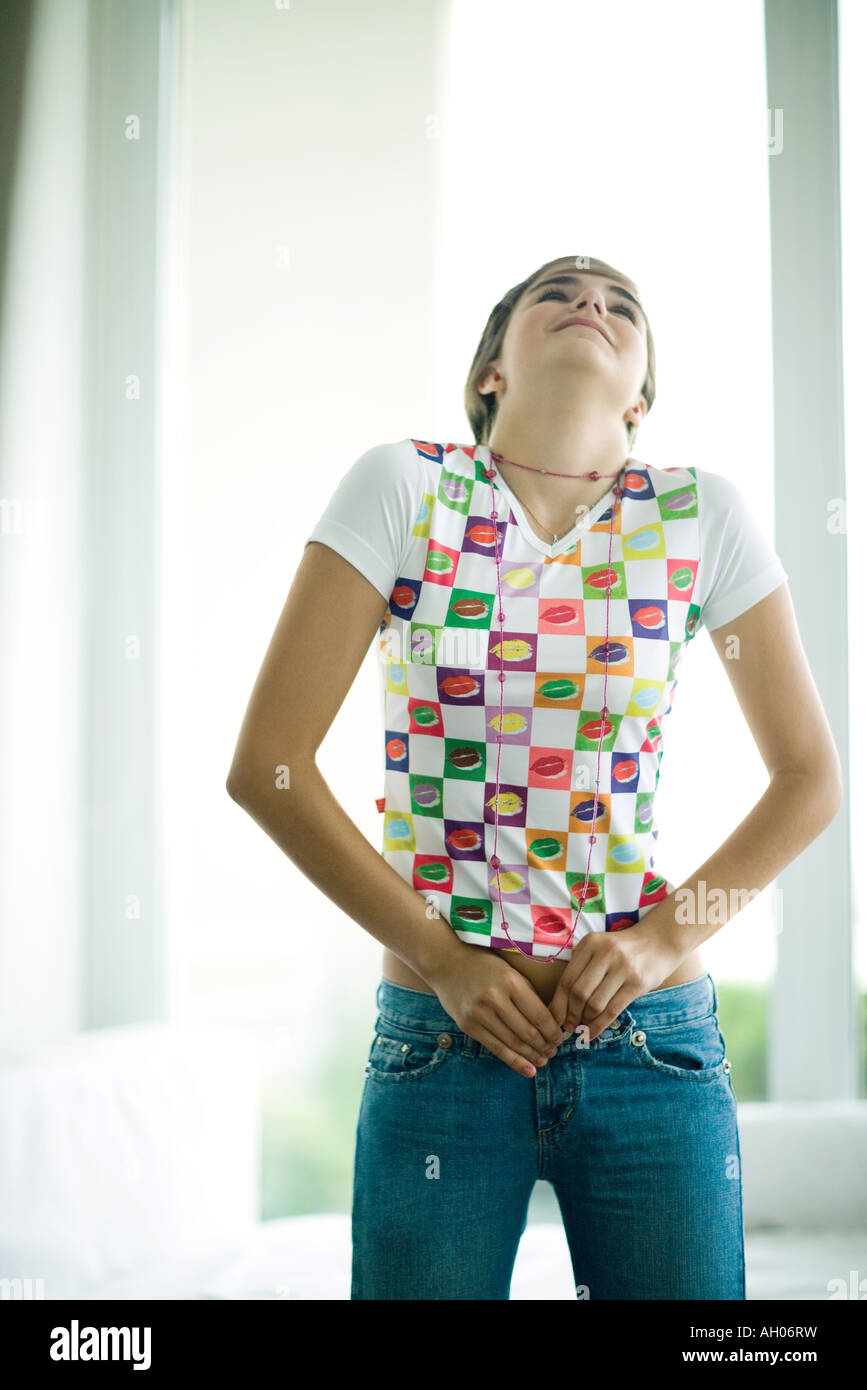 Teen girl trying to button jeans Stock Photo - Alamy