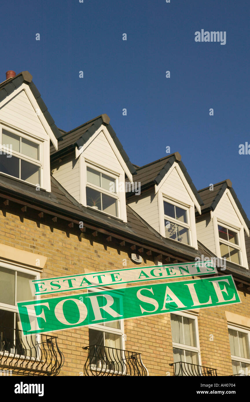For Sale Sign On Block Of Apartments Flats Dormer Windows Stock