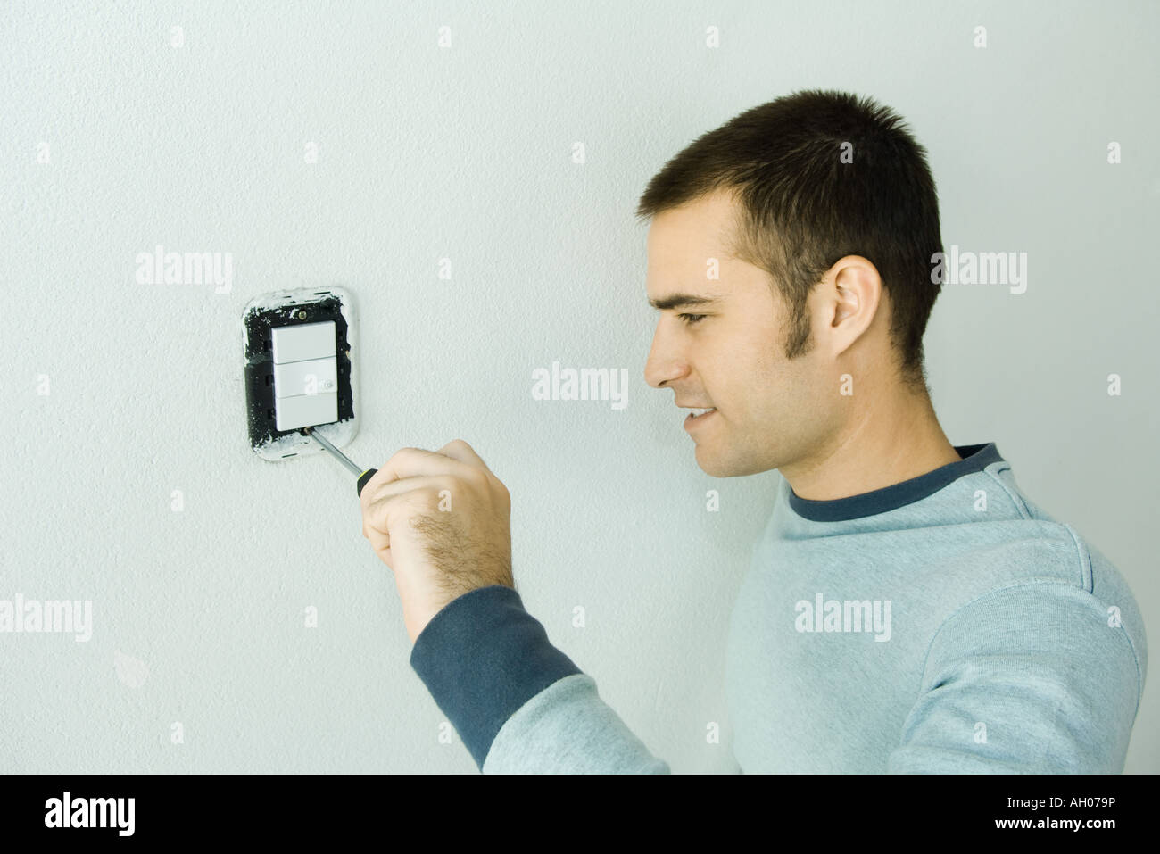 Man removing light switch cover Stock Photo Alamy