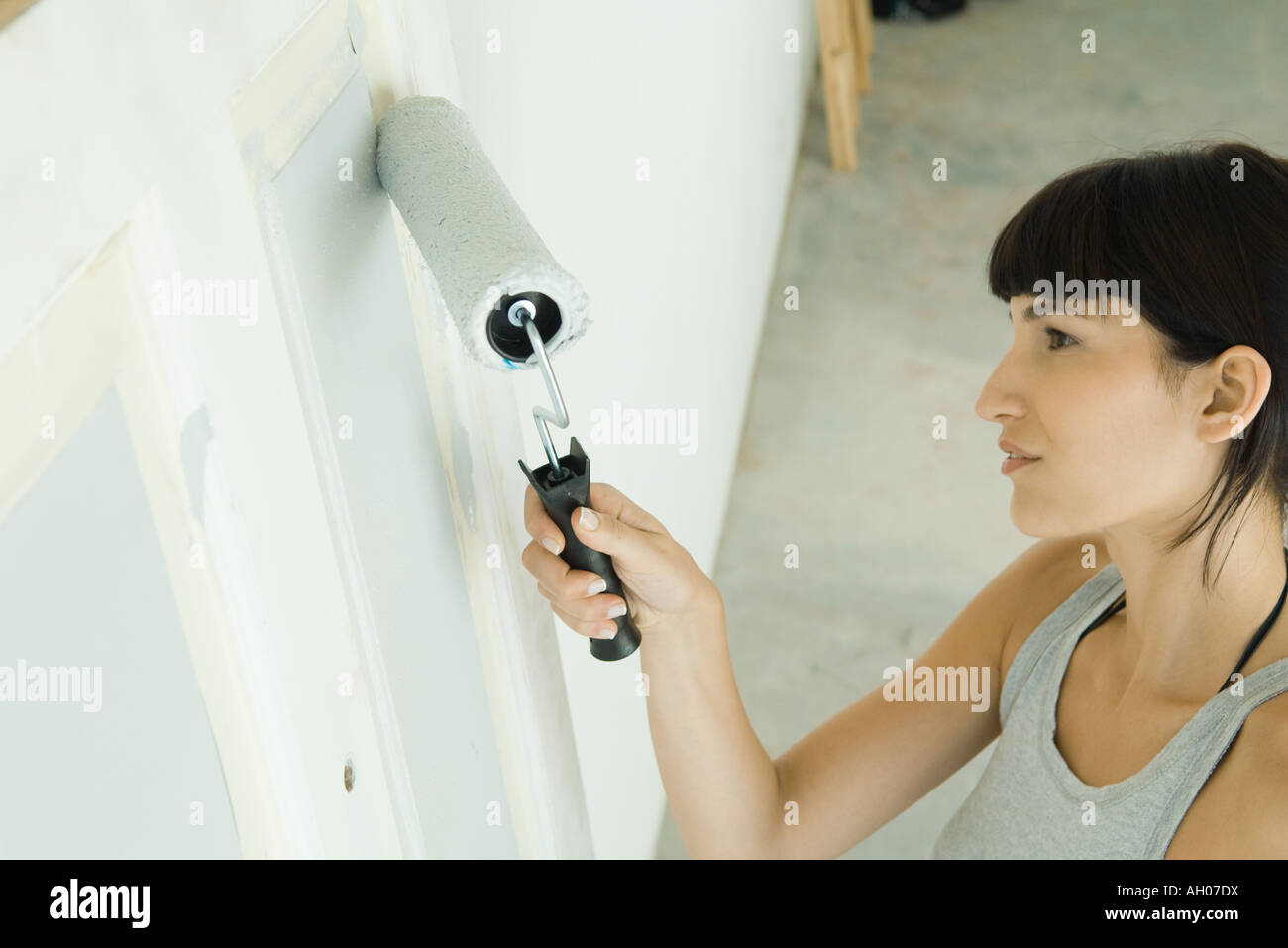 Woman painting door with paint roller Stock Photo Alamy