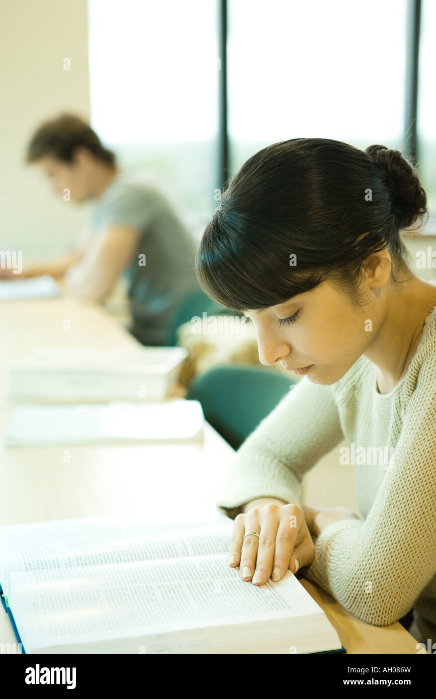 Young woman studying in university library Stock Photo