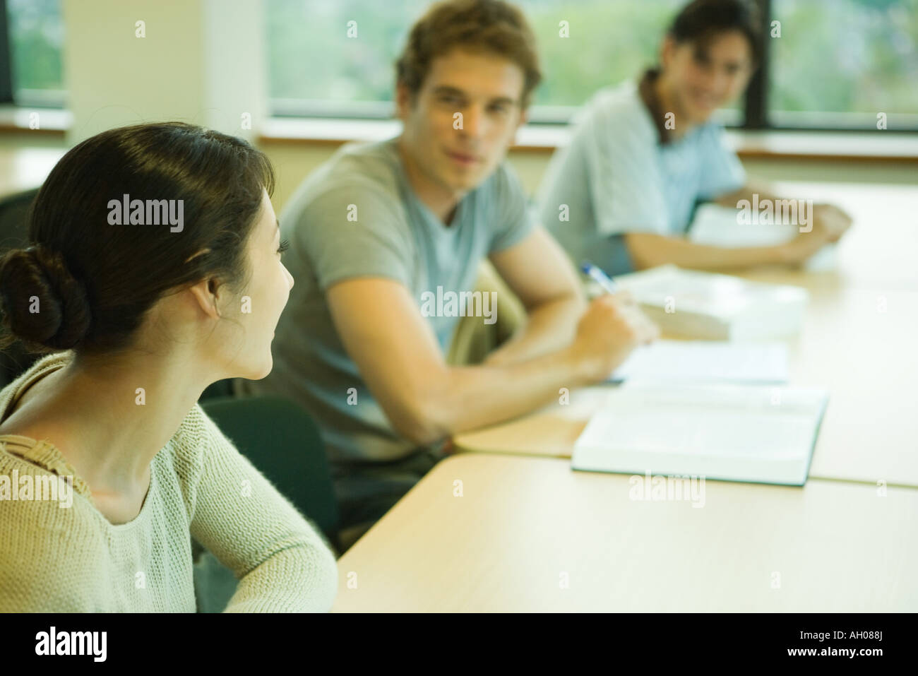 Students studying in university library, chatting with each other Stock ...