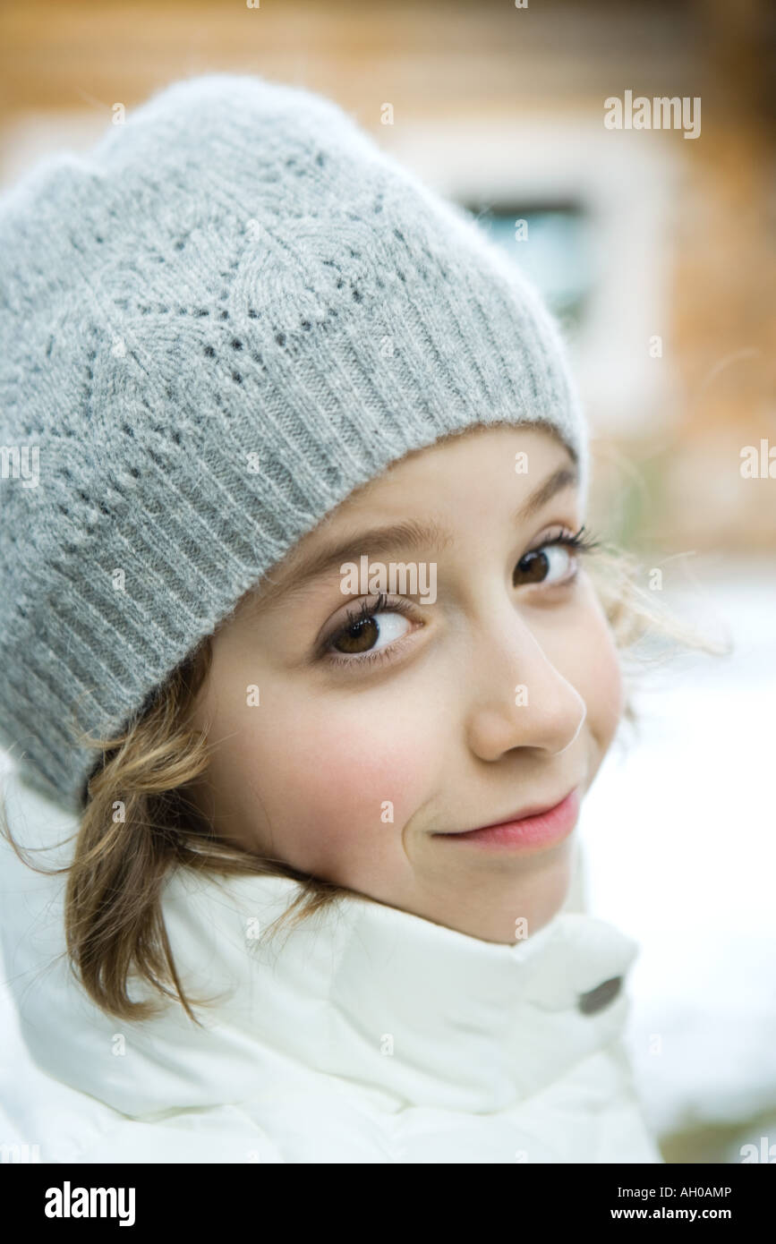 Girl in winter clothes smiling at camera, close-up Stock Photo