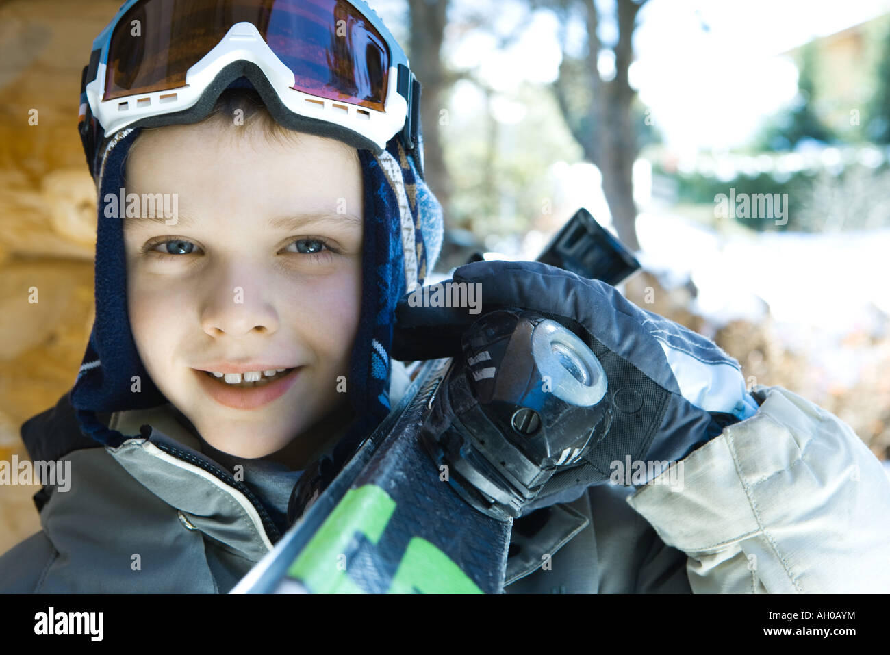 Boy holding skis on shoulder, portrait Stock Photo - Alamy