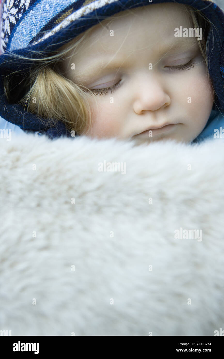 Toddler girl, sleeping under fur blanket, portrait Stock Photo Alamy