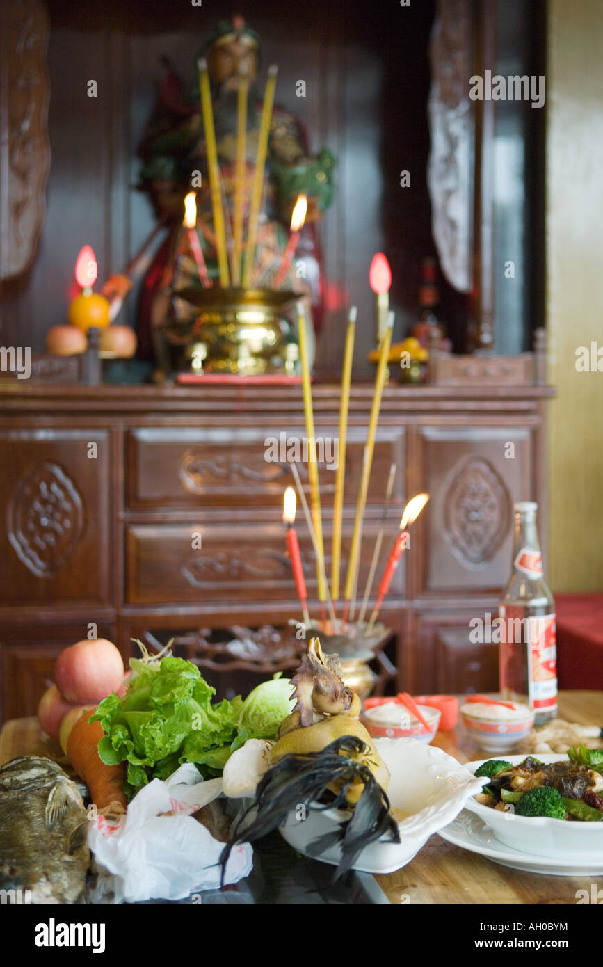 Food, incense and candles on table as religious offering Stock Photo