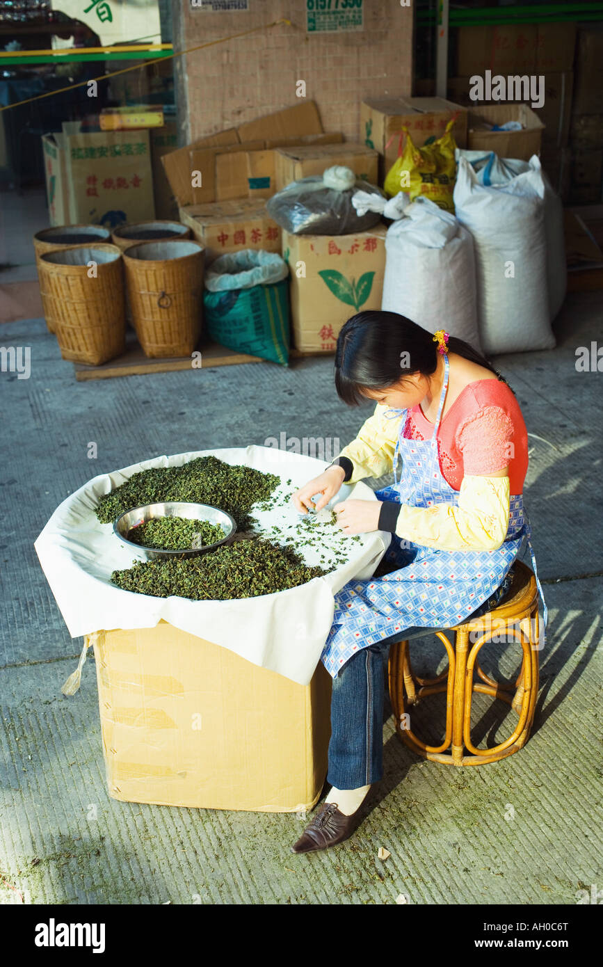 Woman sorting tea leaves in market Stock Photo Alamy